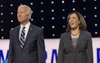 Joe Biden and Kamala Harris pose for the photo spray during a commercial break at the second of two Democratic Debates in Detroit hosted by CNN and sa