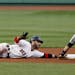 Boston Red Sox's Dustin Pedroia calls for time out after sliding in safely with a double as Minnesota Twins second baseman Brian Dozier fields the thr