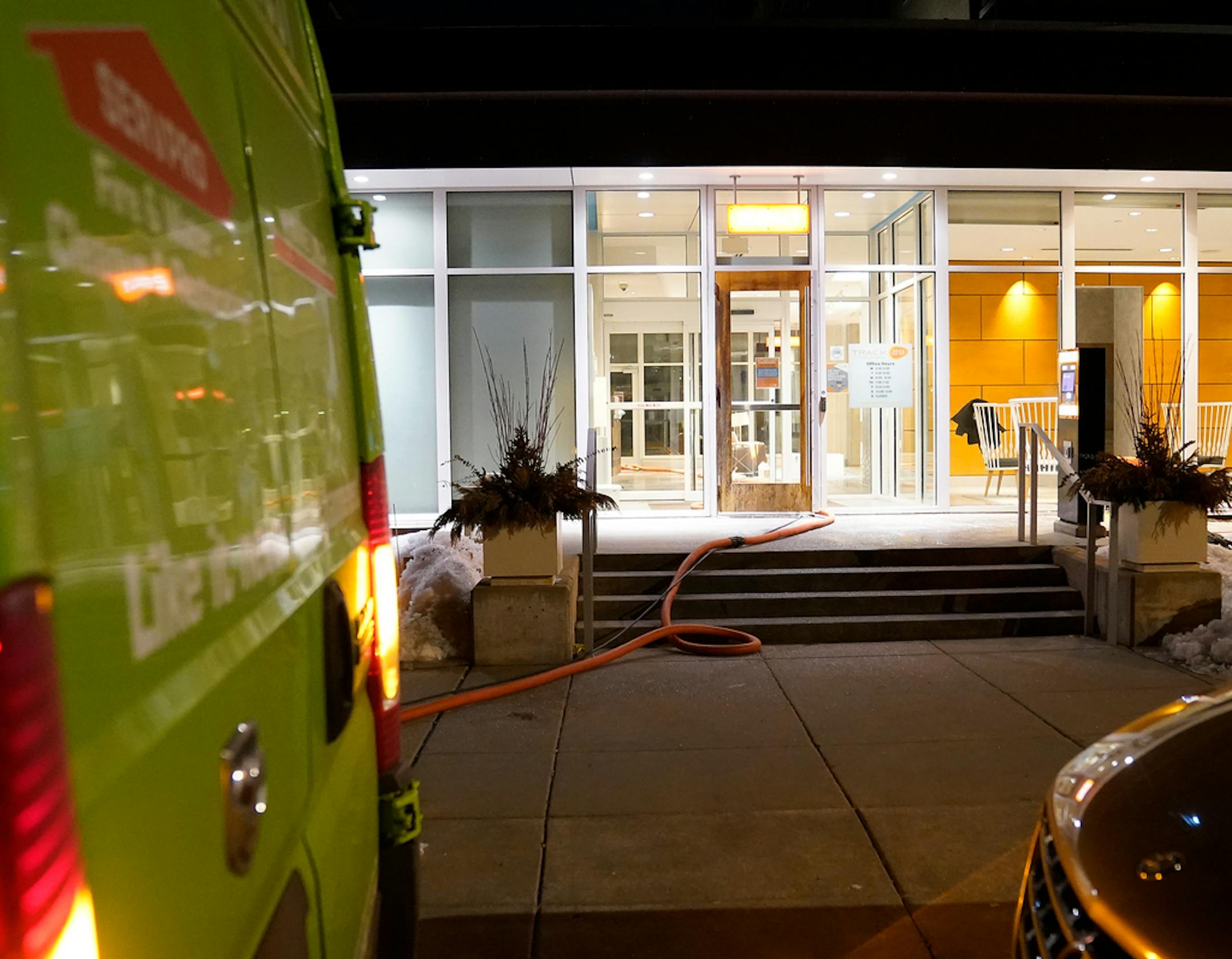 Hose from a cleaning crew is visible going from a truck into an apartment complex on Bryant Ave. S., near 29th St., where two shootings minutes and a block apart in south Minneapolis late Wednesday left two people dead and a third person wounded Thursday, Feb. 16, 2023 in Minneapolis, Minn. ]