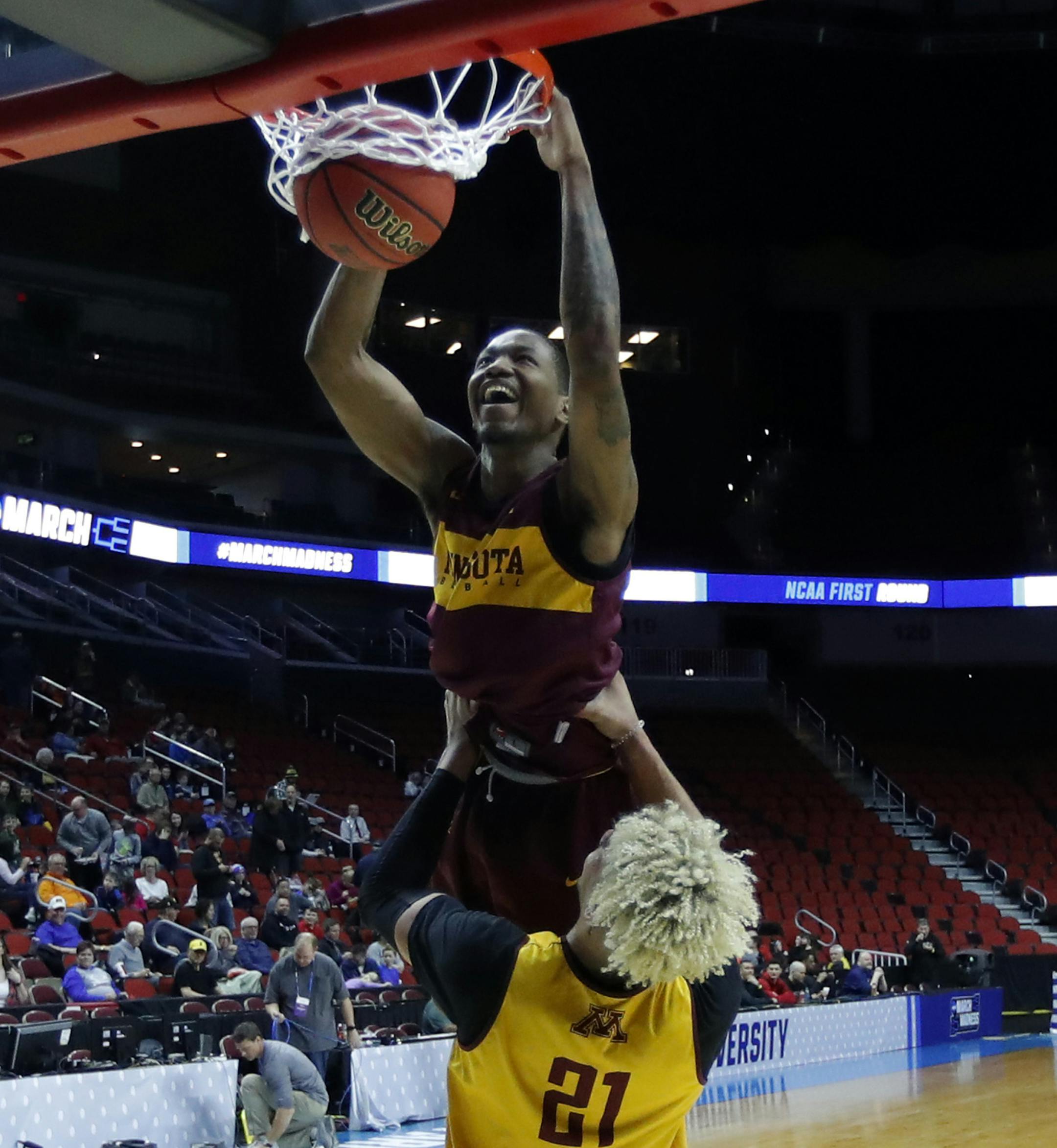 Minnesota guard Dupree McBrayer gets help from teammate Jarvis Omersa (21) while dunking the ball during practice at the NCAA men's college basketball tournament, Wednesday, March 20, 2019, in Des Moines, Iowa. Minnesota plays Louisville on Thursday. (AP Photo/Charlie Neibergall)