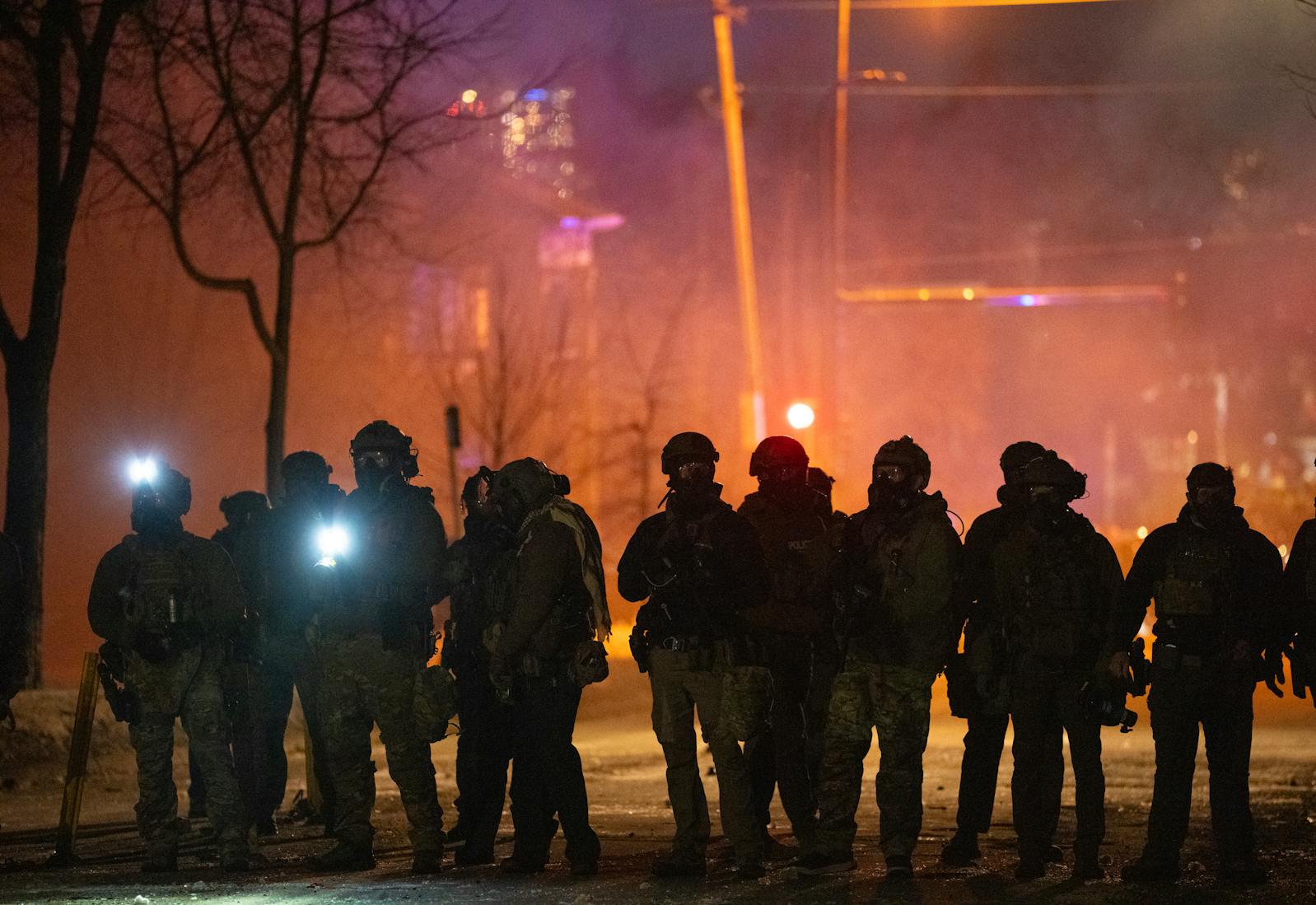 Federal agents array in the intersection of Lyndale Avenue N. in Minneapolis on Jan. 14. Protesters converged on a few blocks in north Minneapolis after a federal agent shot a man in the leg. 