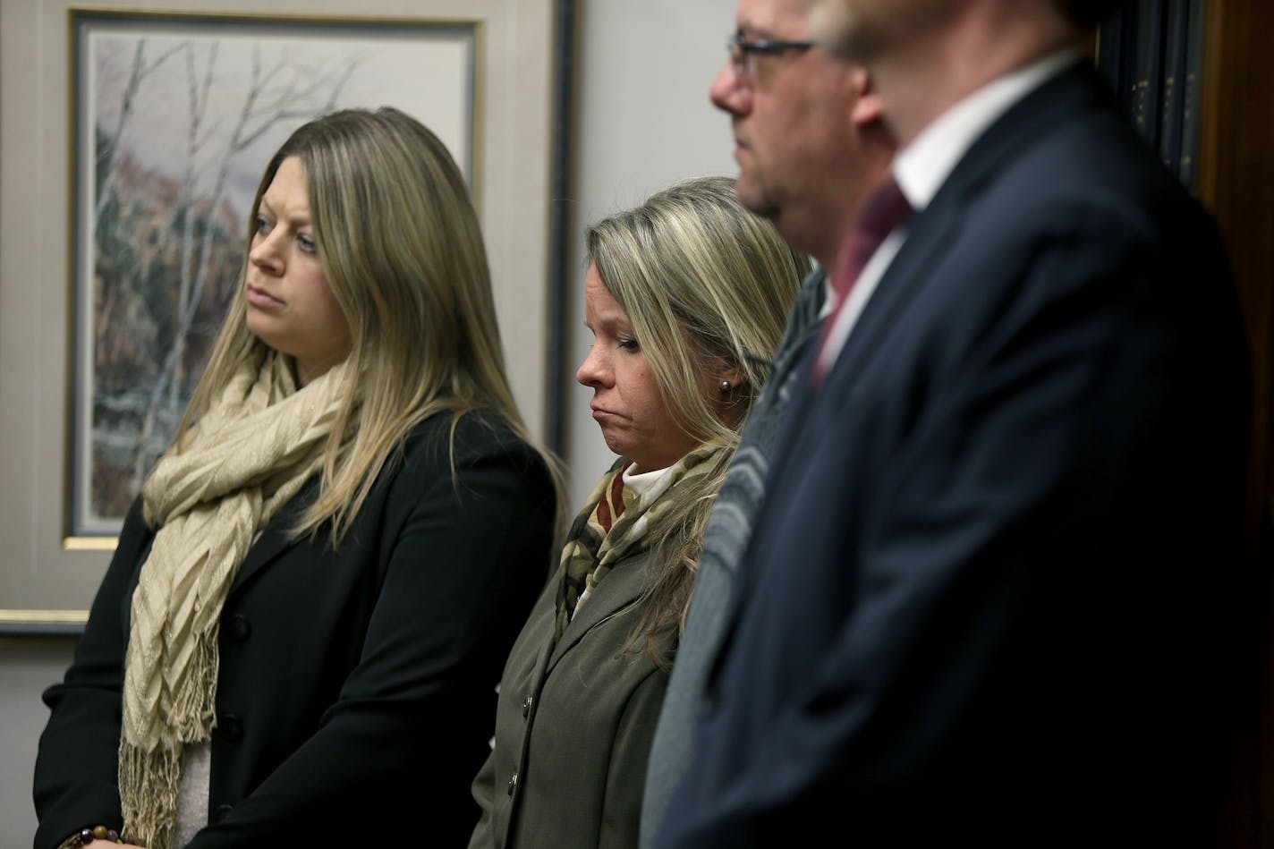 Debt collector victims, including, Jennifer Dahlke, center stood near Minnesota Attorney General Lori Swanson as she talked about suing a Minnesota debt buyer.