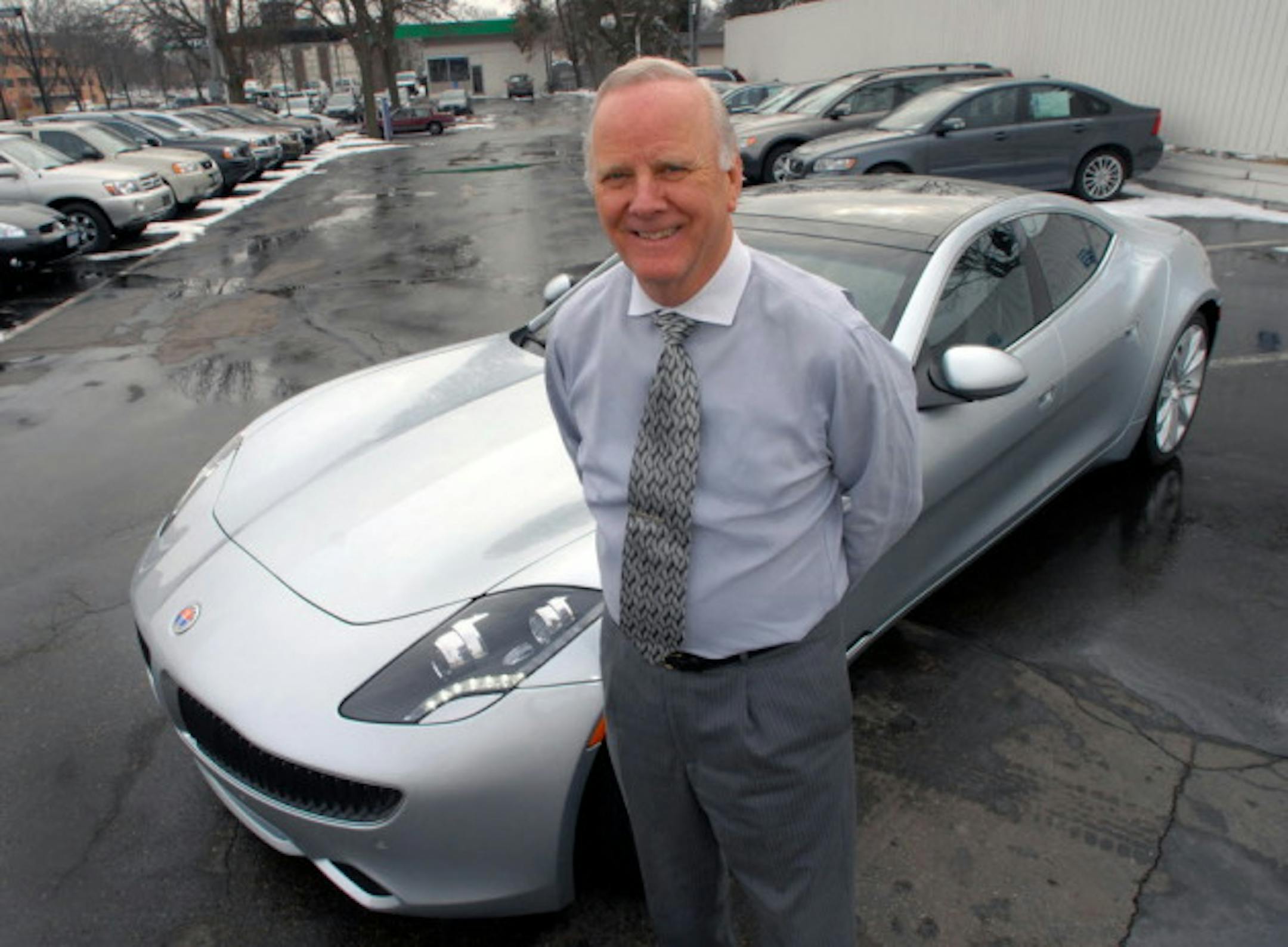 In this 2012 photo, Kjell Bergh, chairman of Borton Volvo, stands aside a Fisker Karma, a hybrid luxury sports car. Photo by Joey McLeister