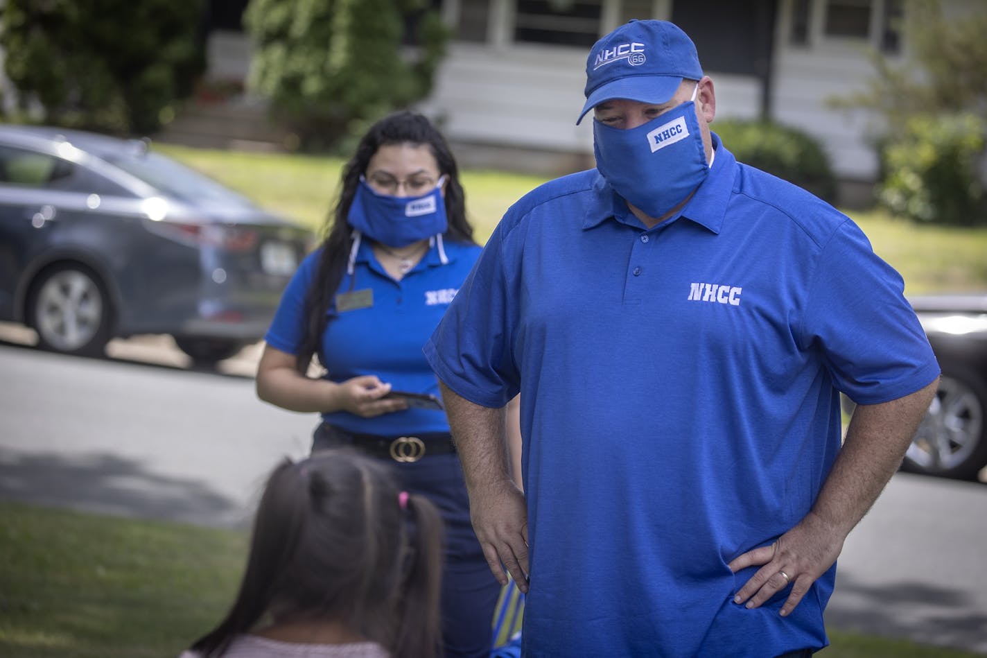 North Hennepin Community College President Rolando Garcia made a home visit with new student Danna Dominguez, right, and her little sister Rebecca Dominguez, as he delivered welcome bags to new students on July 29 in Brooklyn Park.