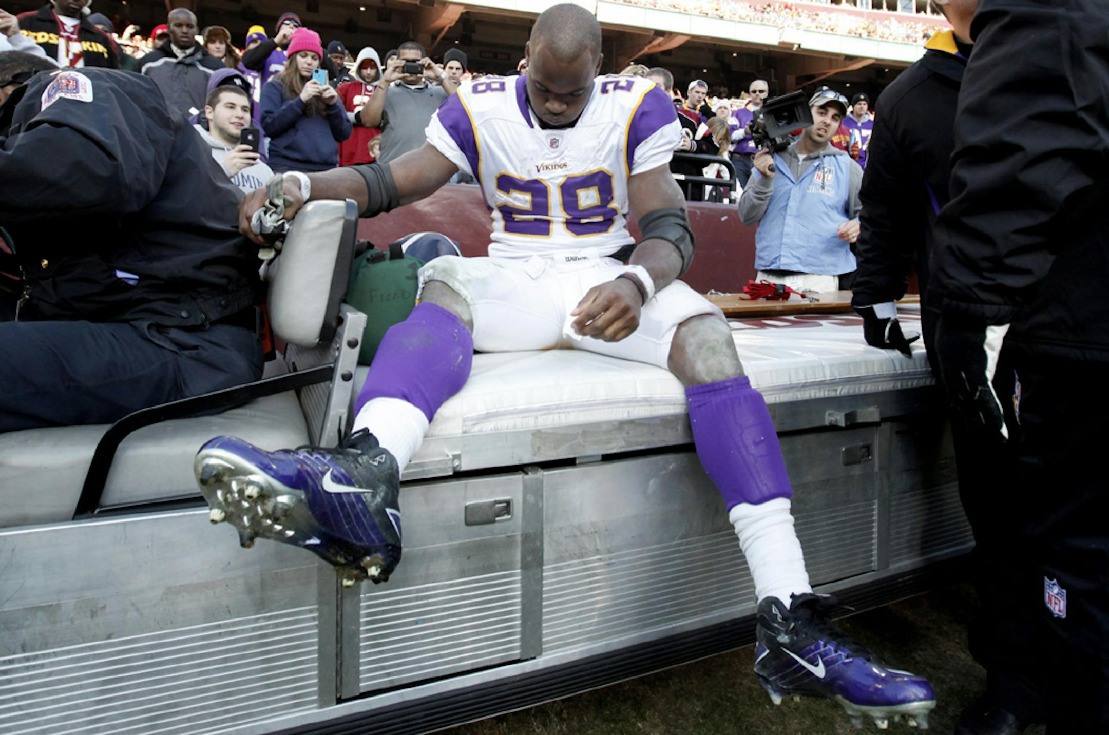 Vikings running back Adrian Peterson left the game on a cart early in the third quarter because of a severe knee injury. He was scheduled for an MRI later Saturday.