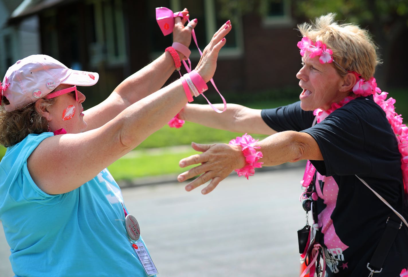 Walkers participating in the Susan G Komen 3-Day trek approached a pit stop near Brackett Recreation Center in Minneapolis. Walker Suzy Warren of Center City, right, hugged volunteer Cathy Cooper.