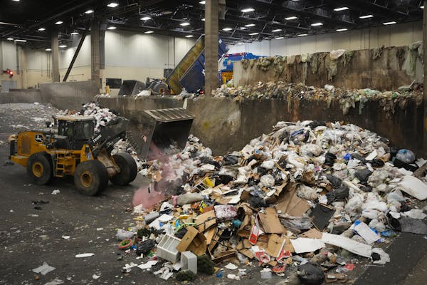 A front-loader moves trash around a holding area until a transport trailer is available to fill at the Transfer Center on Friday, March 3, in Brooklyn