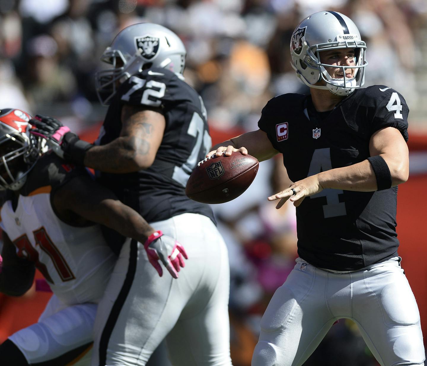 Oakland Raiders quarterback Derek Carr (4) throws a pass against the Tampa Bay Buccaneers during the fourth quarter of an NFL football game Sunday, Oct. 30, 2016, in Tampa, Fla. Carr threw for 513 yards in the Raiders 30-24 overtime win. (AP Photo/Jason Behnken)