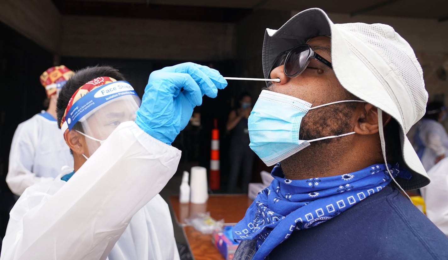 Travis Smith received his first COVID-19 test, administered by Hien Bui Hien Bui during a free testing event at New Salem Baptist Church in Minneapolis. Smith is concerned about the virus since he works around children and was potentially exposed. ] Shari L. Gross • shari.gross@startribune.com