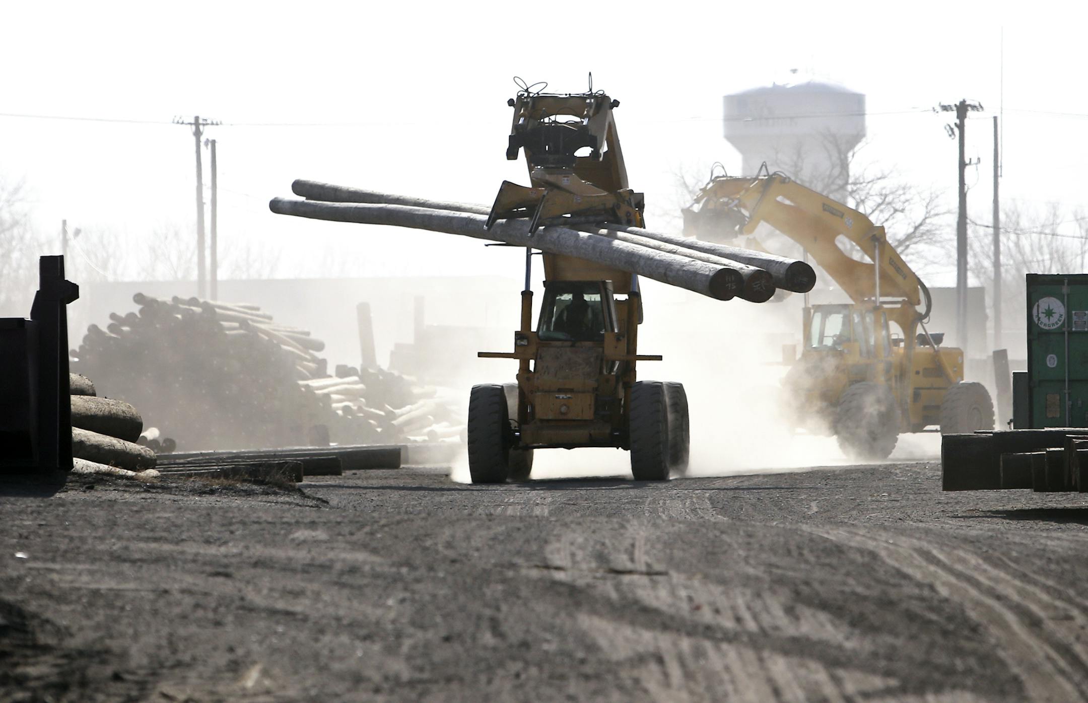 Bell Lumber and Pole's 23 acre facility where poles up to 125 feet long are sorted and pressure treated so they can carry electrical utility lines into neighborhoods Here, a Pettibone carry and lift driver brings a load of poles onto the grounds after unloading them from a nearby semi-truck and trailer Tuesday, Nov. 26, 2013, in New Brighton, MN.](DAVID JOLES/STARTRIBUNE) djoles@startribune.com Great River Energy's economic contribution to the state soared 55 percent this year and is expected to