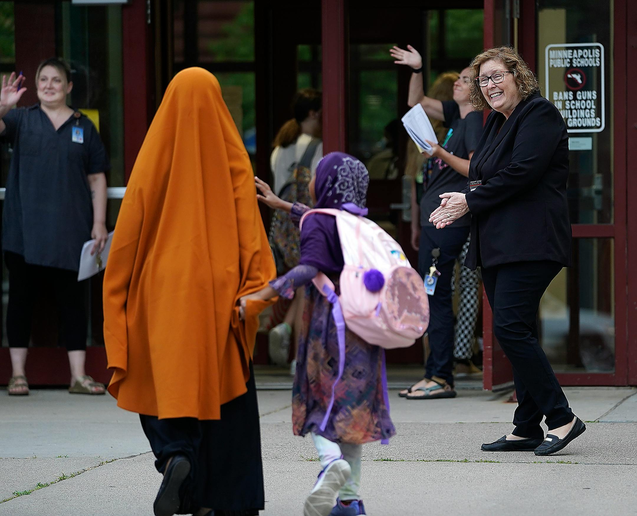 Interim Minneapolis Public Schools Superintendent Rochelle Cox, right, greeted parents and students heading back to school for the first day at Anishinabe Academy and Sullivan STEAM School in Minneapolis.