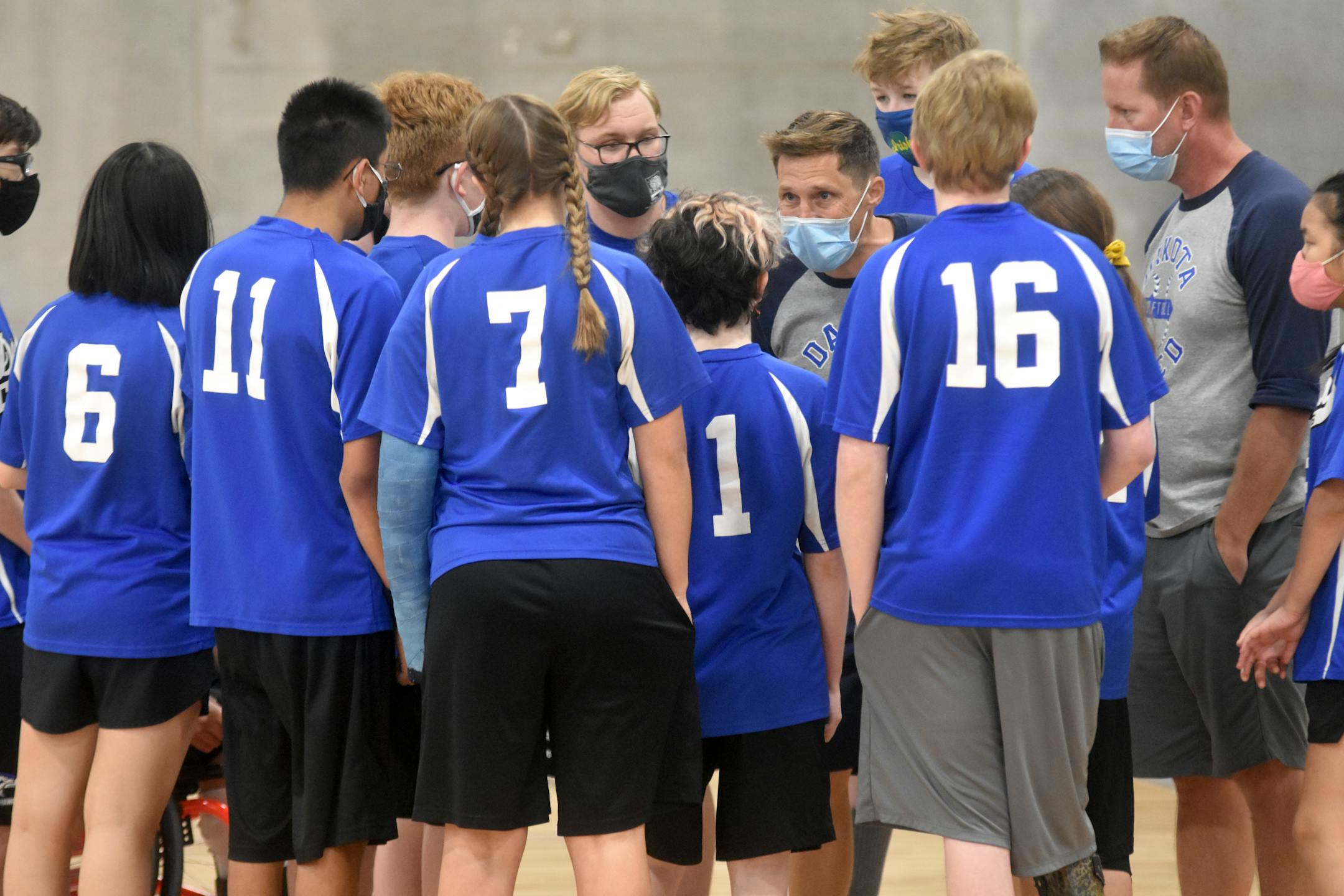 Dakota United coach Brett Kosidowski, center, talks to his adapted softball team during a recent game. Photo: Emily Buss
