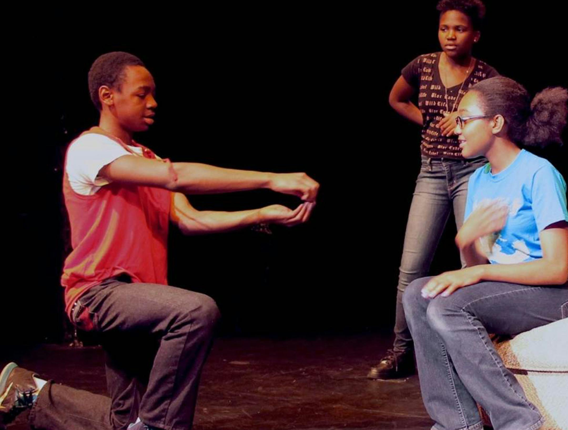 Left to right: Treon Jones (as the Ambassador), Kishya Graham (one of the stepsisters) and Annemarie Martin (Cinderella, seated). Capri Theater