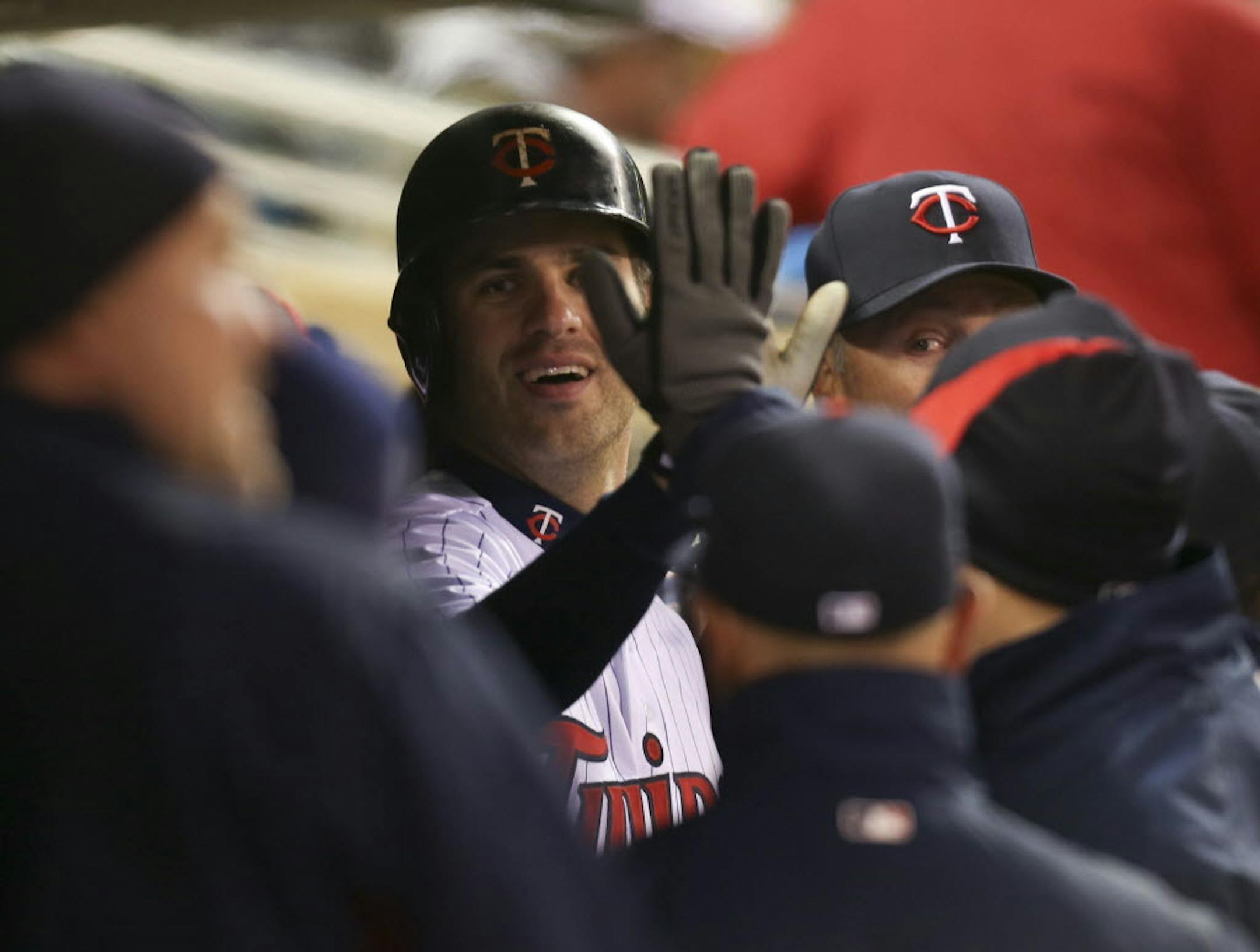 Joe Mauer was congratulated by teammates in the dugout after his fifth-inning home run.