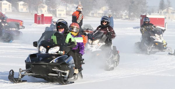 Snowmobilers go for a ride on a frosty morning across Gull Lake during the Minnesota United Snowmobilers Association Winter Rendezvous Friday morning 