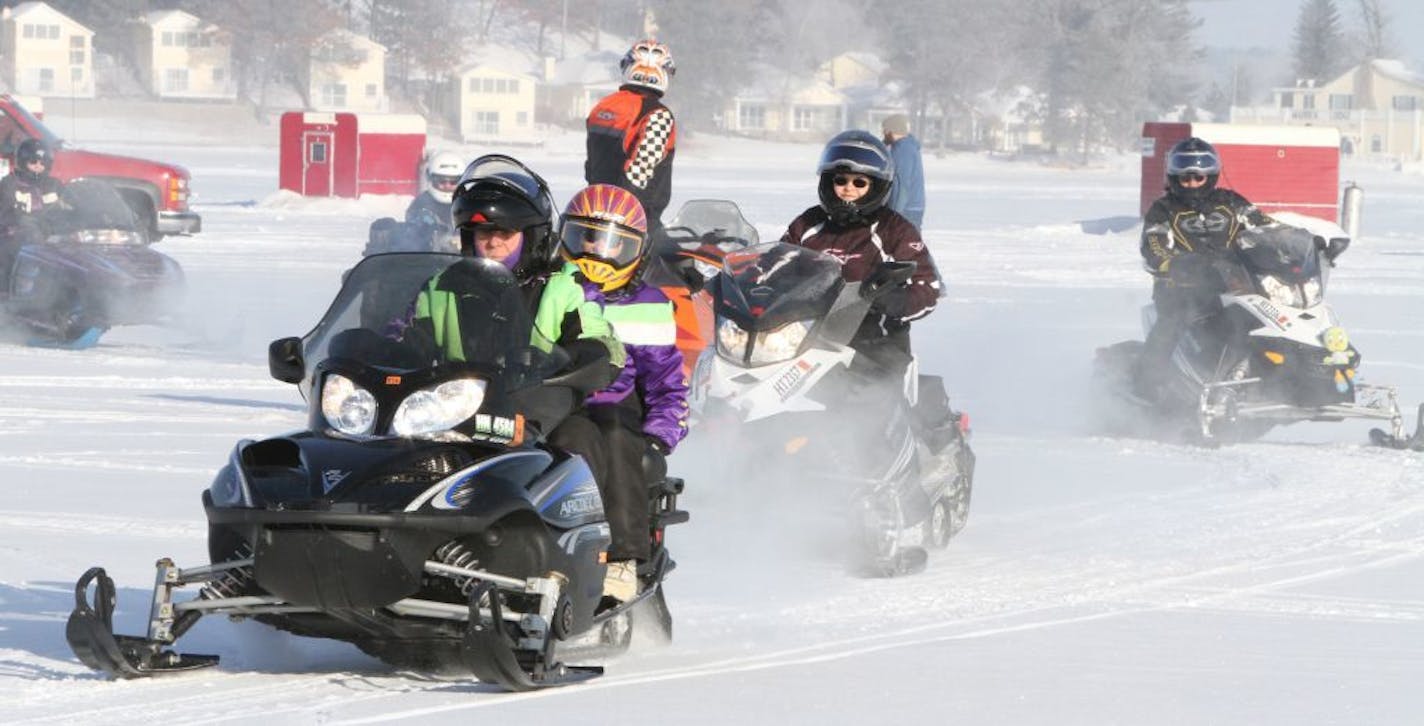 Snowmobilers go for a ride on a frosty morning across Gull Lake during the Minnesota United Snowmobilers Association Winter Rendezvous Friday morning Feb. 8, 2013 in East Gull Lake, Minn.