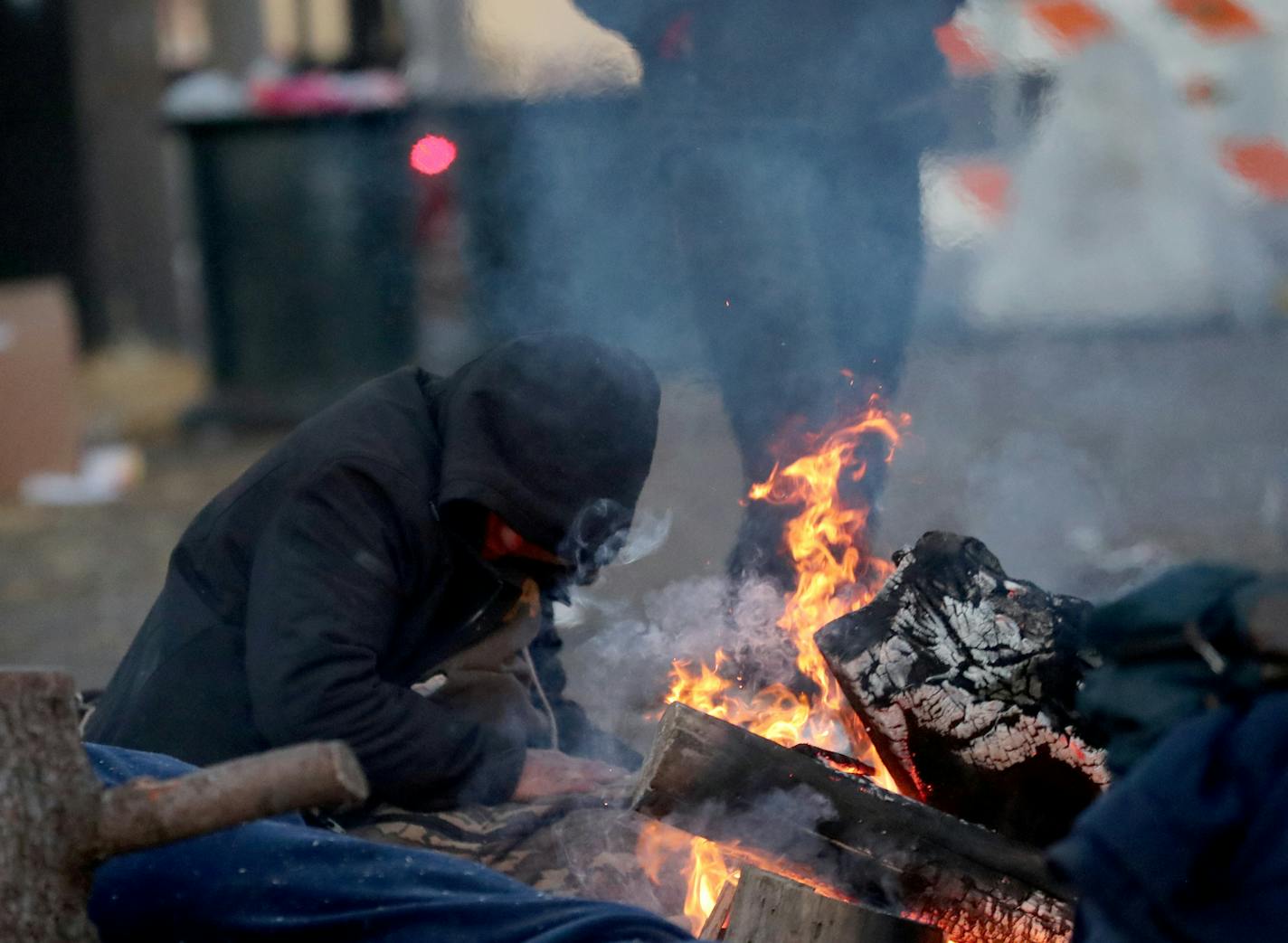 The large homeless camp near the Little Earth housing project in south Minneapolis has finally shut down after five months. Here, in what may have been the last camp fire to burn at the encampment a resident warms himself along E. Franklin Avenue.