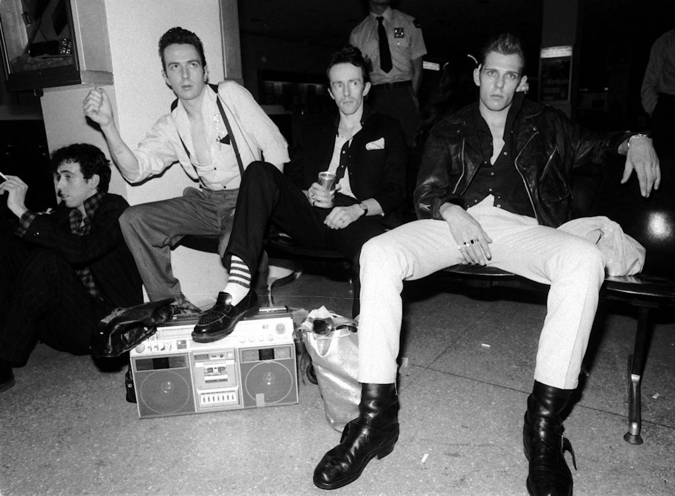 Members of the British rock band the Clash, from left, Mick Jones, Joe Strummer, "Topper" Headon and Paul Simonon, relax at JFK International Airport after arriving in New York in May 1981. The band, popular in the late 1970s and early 1980s, will be inducted into the Rock Hall of Fame in Cleveland March 12, 2003. Strummer, the group's lead singer, died of a heart attack on Dec. 21, 2002.