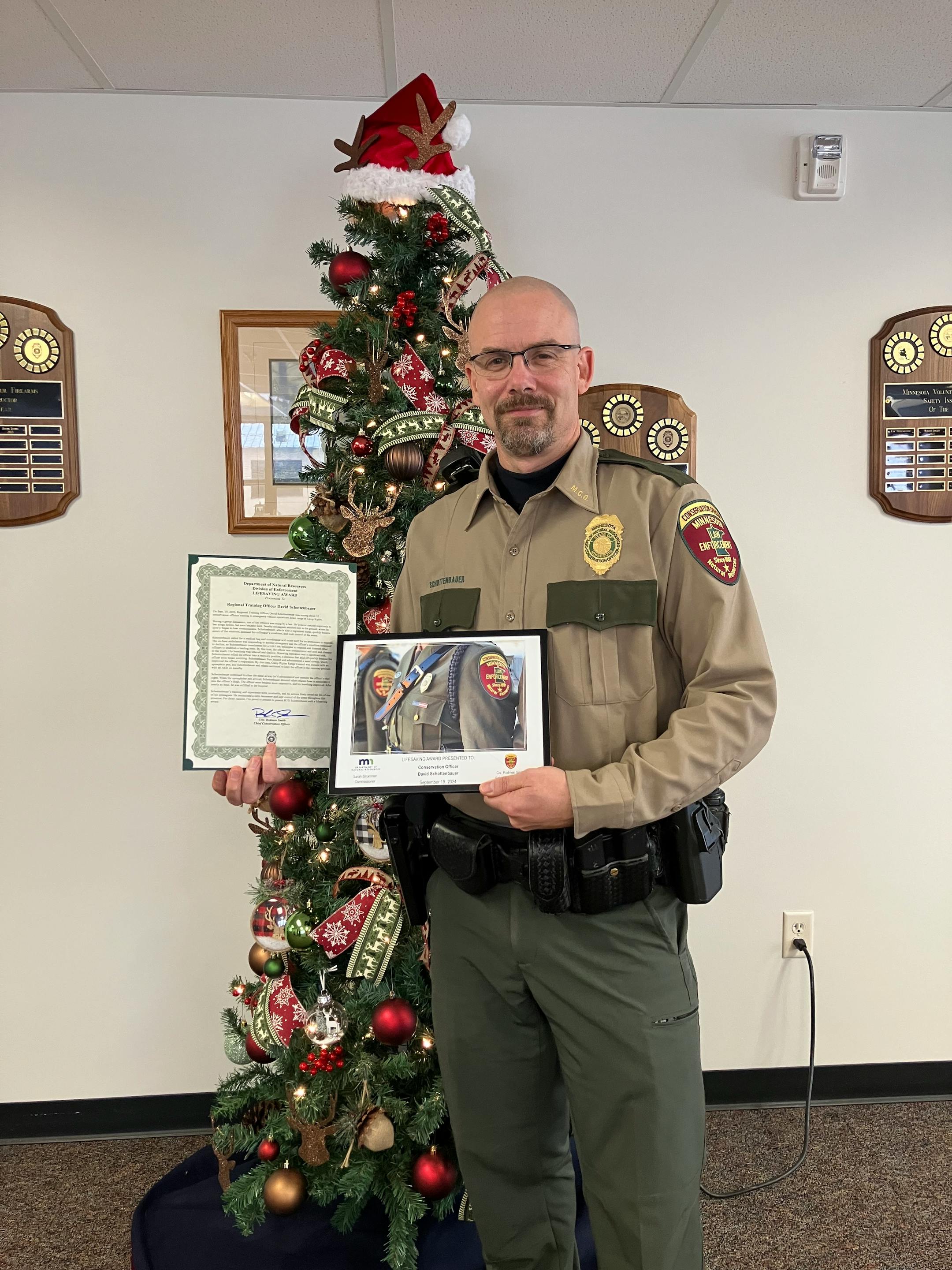 DNR conservation officer Dave Schottenbauer is also a registered nurse, and when a fellow CO was stung by a bee and had a life-threatening reaction he used his training to help save the officer's life. .