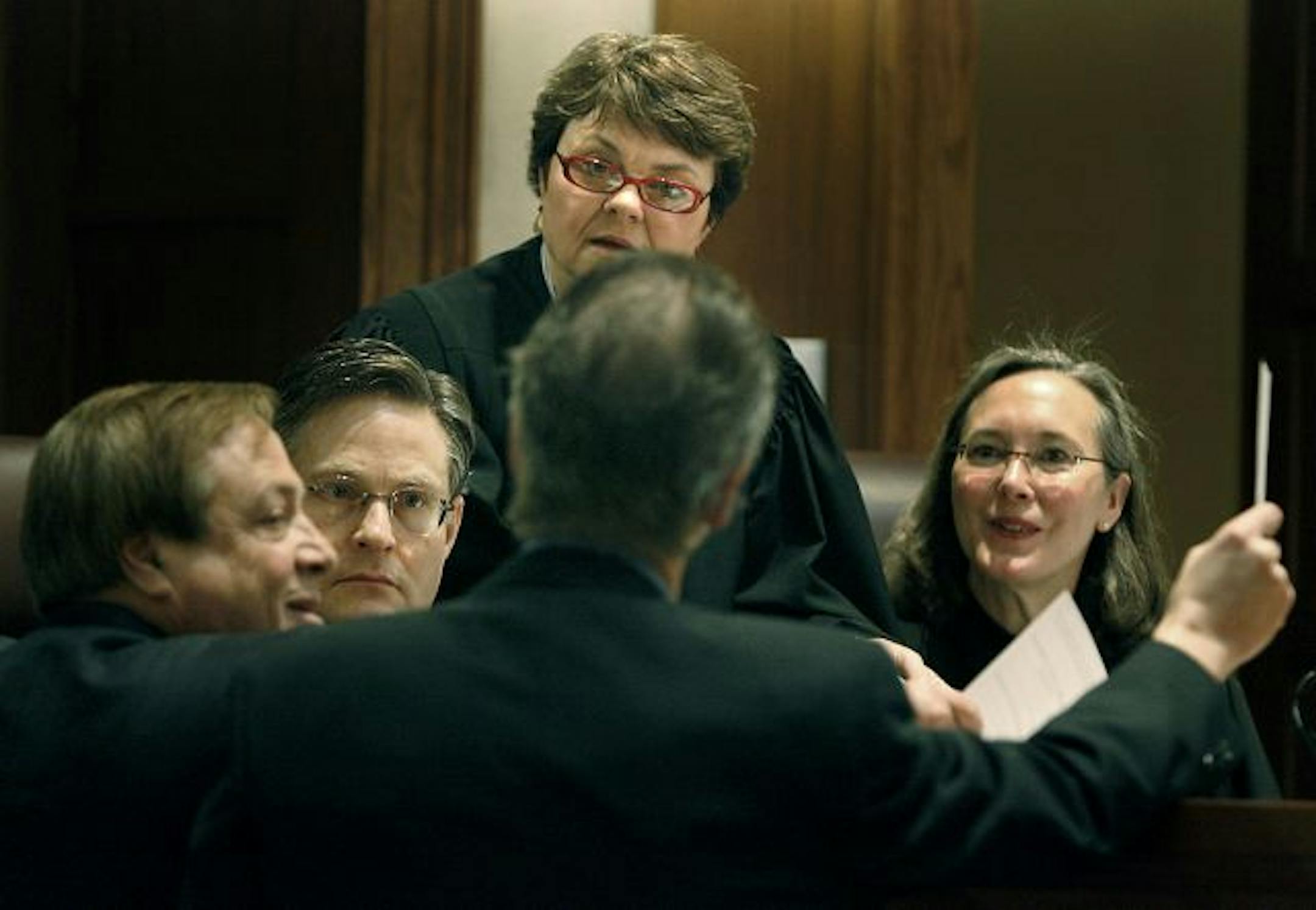 From left, judges Kurt Marben, Elizabeth Hayden and Denise Reilly confer with attorneys Joe Friedberg, left, representing Norm Coleman, and Kevin Hamilton, representing Al Franken, during the Senate recount trial at the Minnesota Judicial Center.