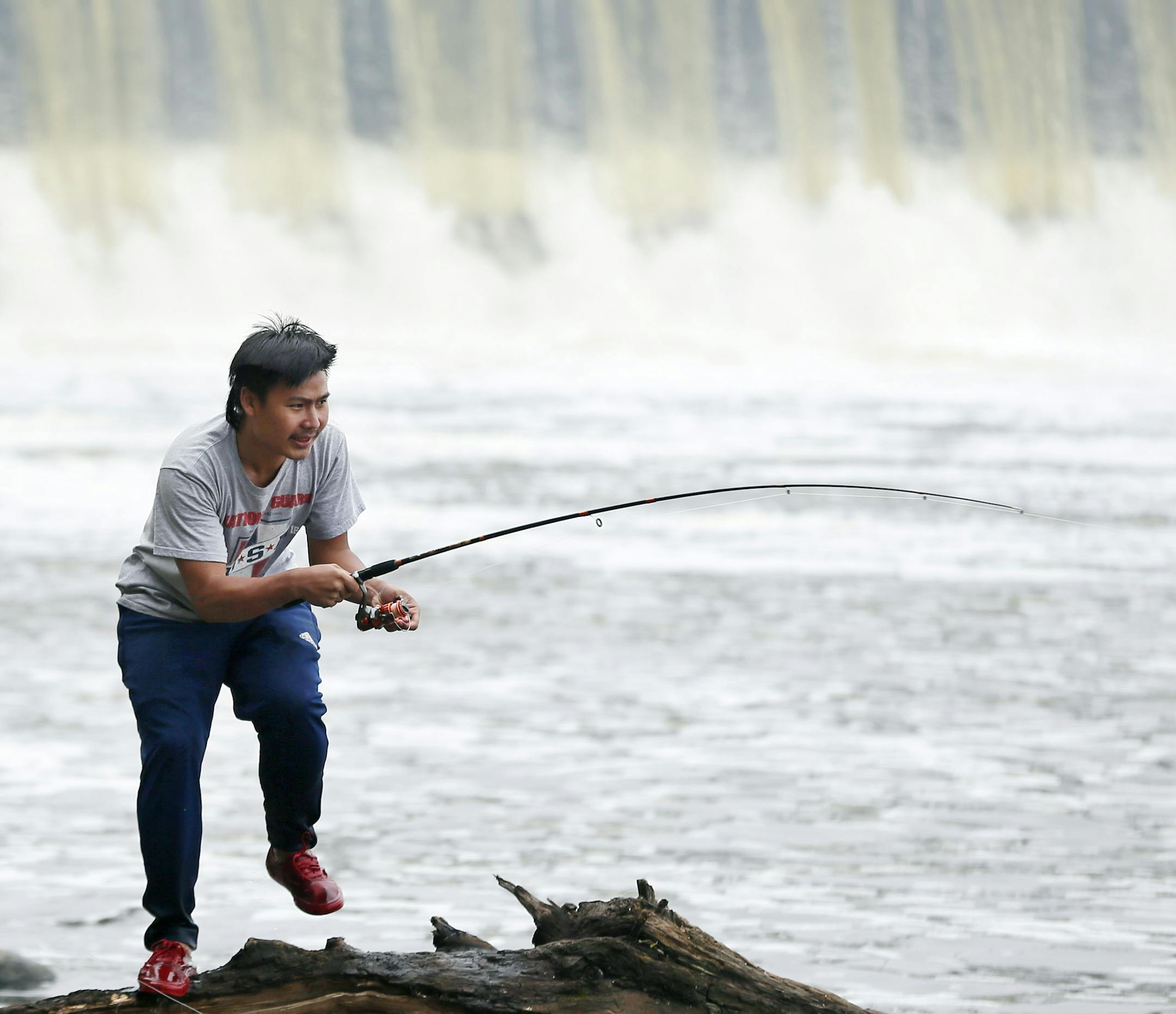 Thay Paw pulled in a carp while fishing in the Mississippi River at the Coon Rapids Dam Regional Park Monday July 6, ,2015 in Brooklyn MN.] Jerry Holt/ Jerry.Holt@Startribune.com