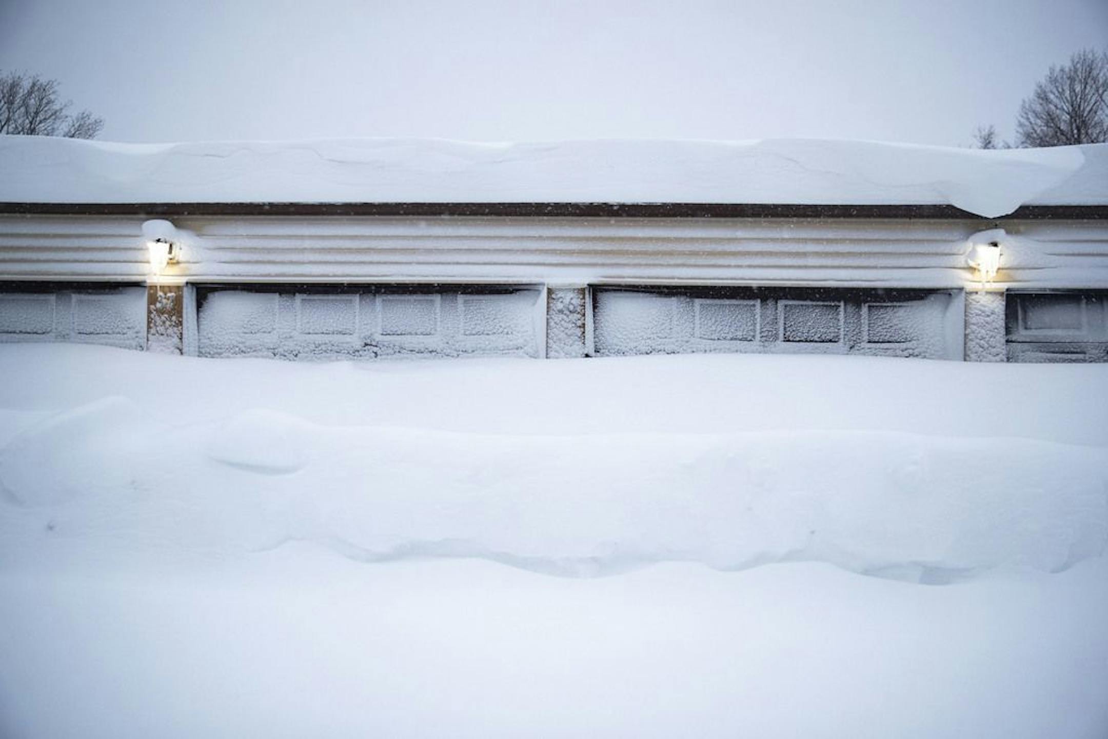Around five feet of snow built up against garages in the Highland Chateau apartment complex. Gale force winds caused massive snow drifts around Duluth that caused piles of snow more than four feet high in some places..