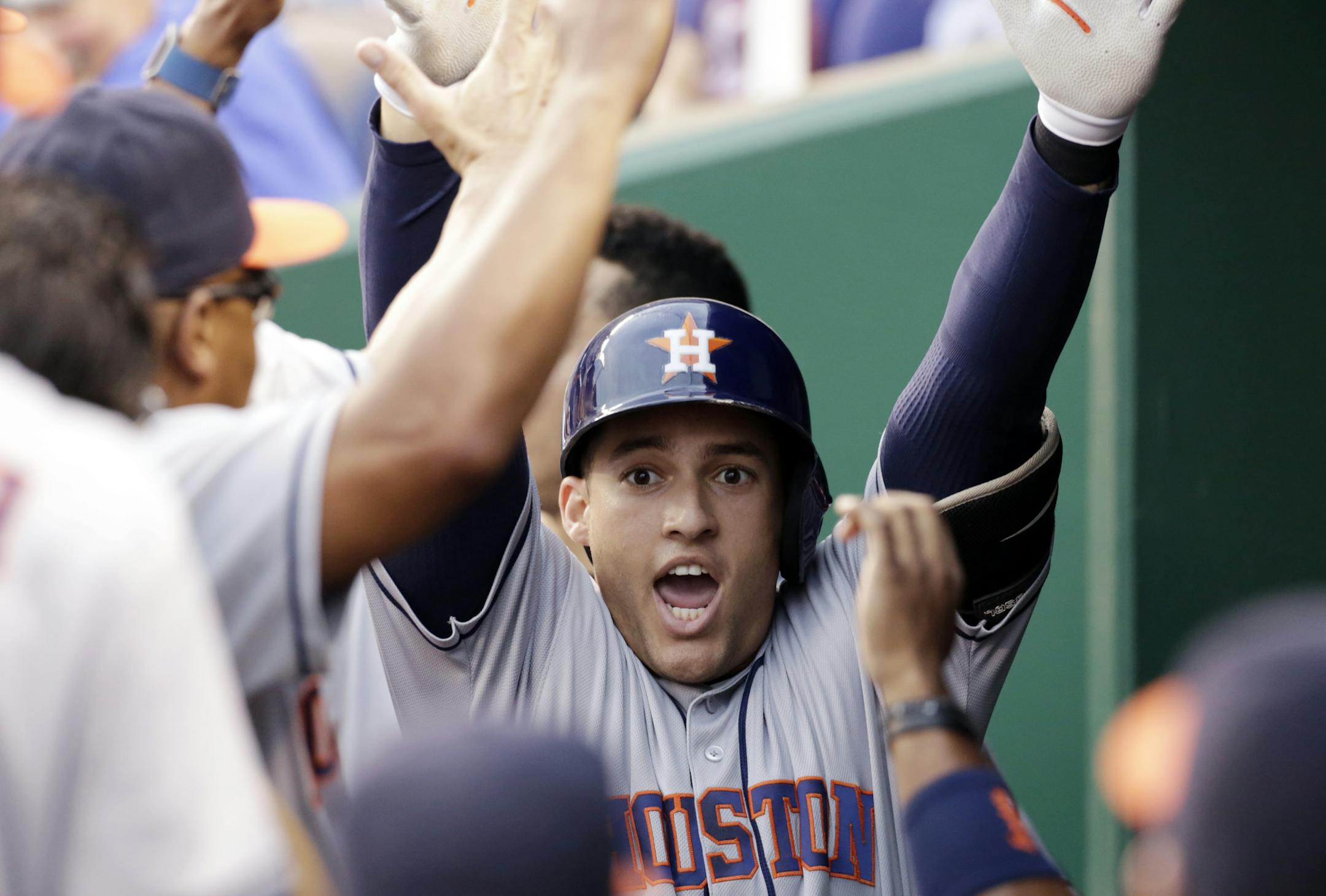 Houston Astros George Springer is congratulated in the dugout after hitting a grand slam in the first inning of a baseball game against the Kansas City Royals at Kauffman Stadium in Kansas City, Mo., Friday, June 24, 2016. (AP Photo/Colin E. Braley)