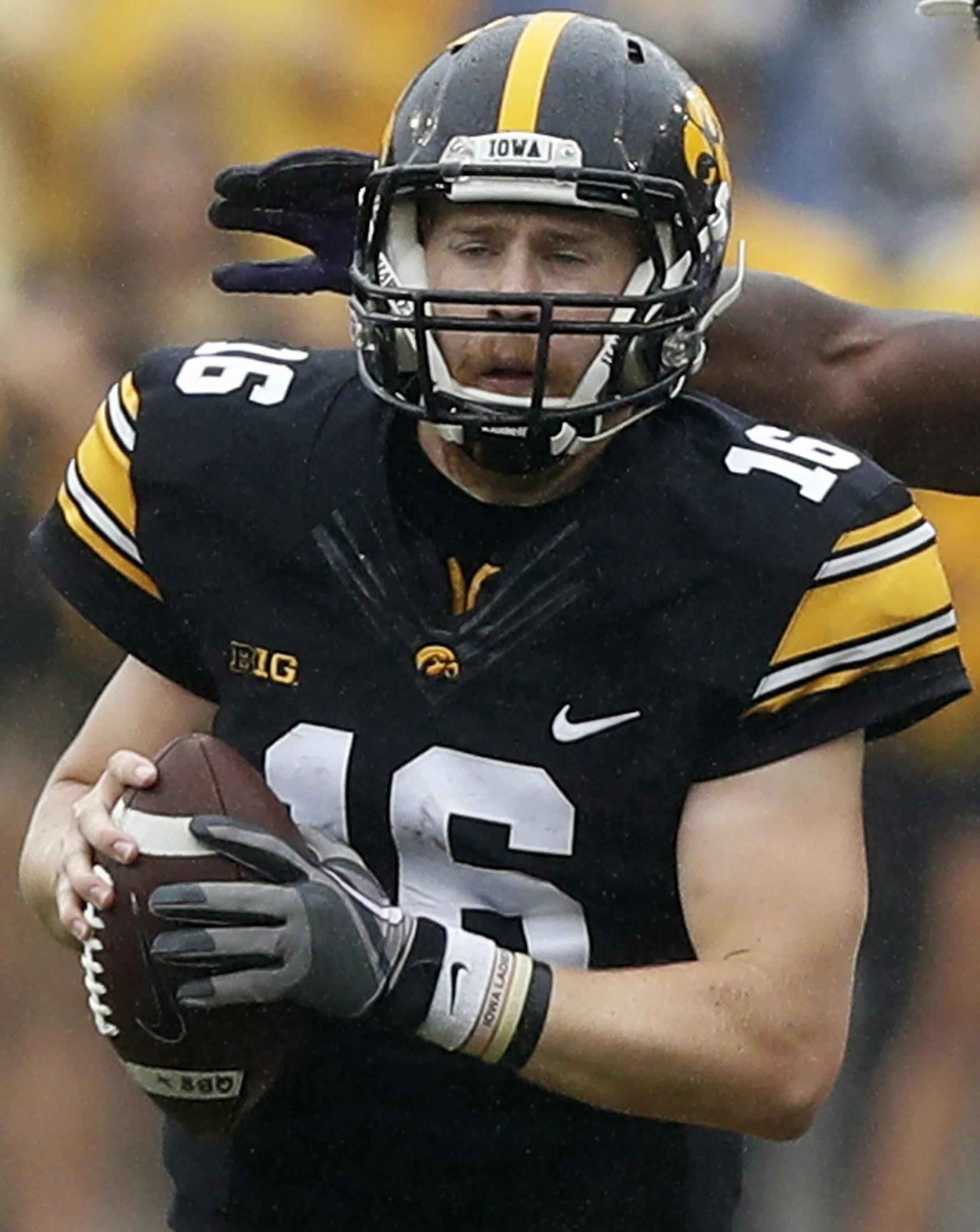 Iowa quarterback C.J. Beathard (16) runs from Northwestern defensive lineman Ifeadi Odenigbo (7) during the second half of an NCAA college football game, Saturday, Oct. 1, 2016, in Iowa City, Iowa. Northwestern won 38-31. (AP Photo/Charlie Neibergall)