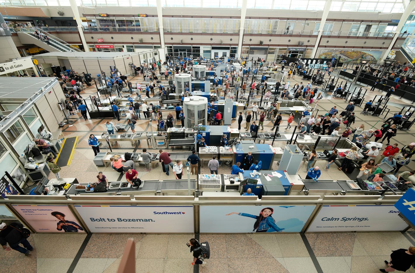 FILE - Travelers queue up at the south security checkpoint in the main terminal of Denver International Airport, Thursday, May 26, 2022, in Denver. The unofficial start of summer over the Memorial Day weekend offers a troubling glimpse of what lies ahead for travelers during the peak vacation season. U.S. airlines canceled more than 2,800 flights from Thursday through Monday, or about 2% of their schedules, according to tracking service FlightAware.(AP Photo/David Zalubowski, File)