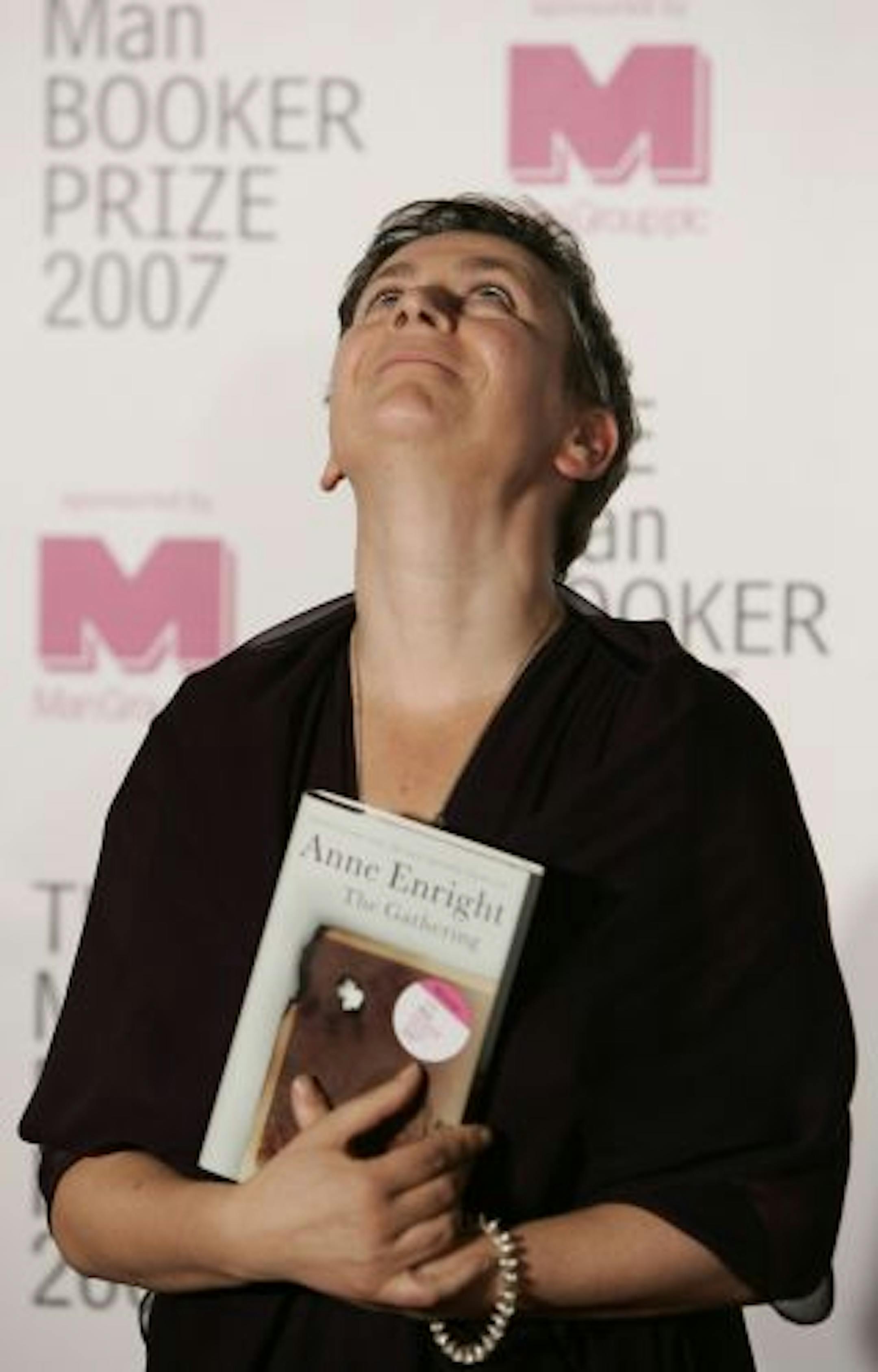 Irish writer Anne Enright holds a copy of her book after she won the Man Booker fiction prize for "The Gathering," an uncompromising portrait of a troubled family that its author called the literary equivalent of a Hollywood weepie, in London Tuesday Oct. 16 2007.