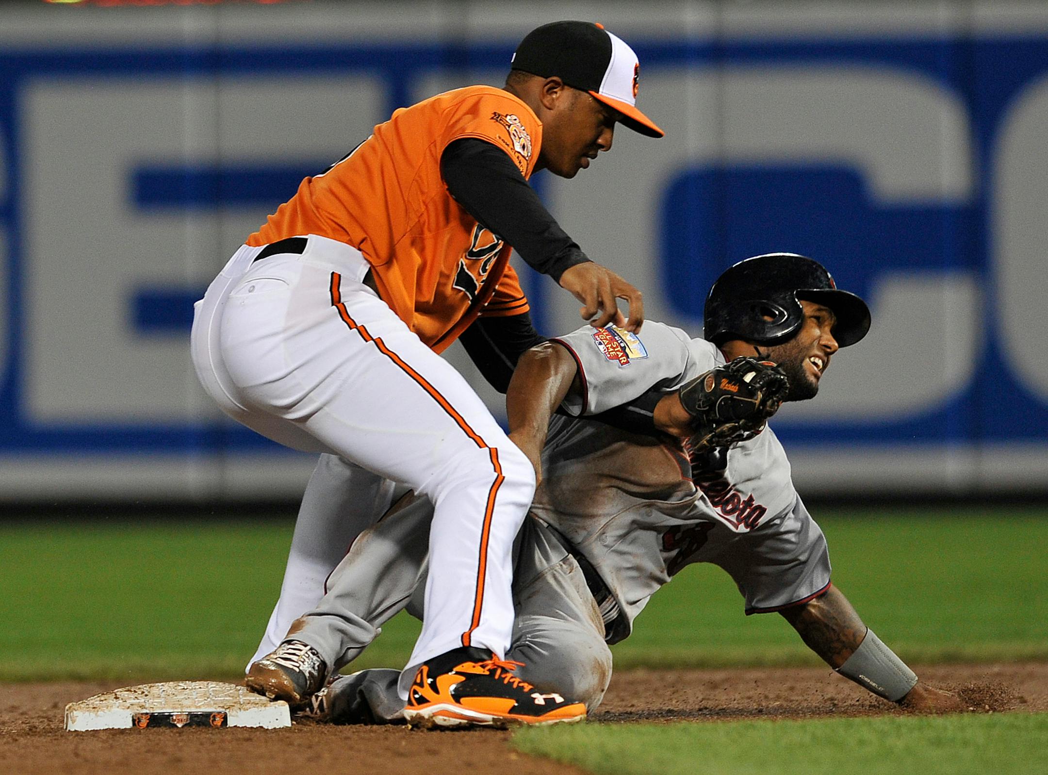 Baltimore Orioles second baseman Jonathan Schoop, right, tags out Minnesota Twins Danny Santana on a steal attempt in the third inning of a baseball game, Saturday, Aug. 30, 2014, in Baltimore.(AP Photo/Gail Burton)