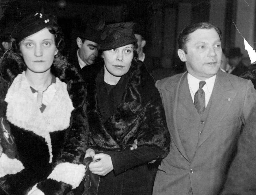 Isadore Blumenfeld walked with his wife Lillian, center, and his sister, left, after being acquitted for the murder of Walter Liggett. 'I'm going home -- to see momma,' he said.