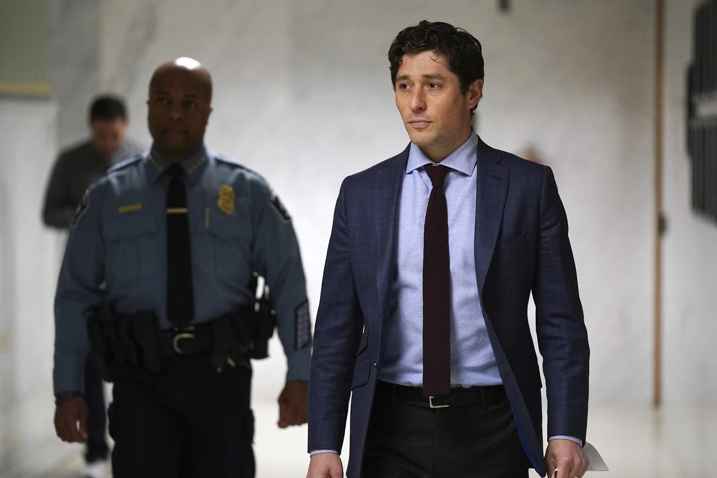 Minneapolis Mayor Jacob Frey, walking a distance from police Chief Medaria Arradondo, arrives at a news conference to outline how the city will enforce the new stay-at-home order, Friday, March 27, 2020, in Minneapolis. A stay-at-home order takes effect at midnight Friday as Minnesota tries to prevent the COVID-19 pandemic, which is expected to peak in the coming weeks, from overloading the state's health care system.(Anthony Souffle/Star Tribune via AP)