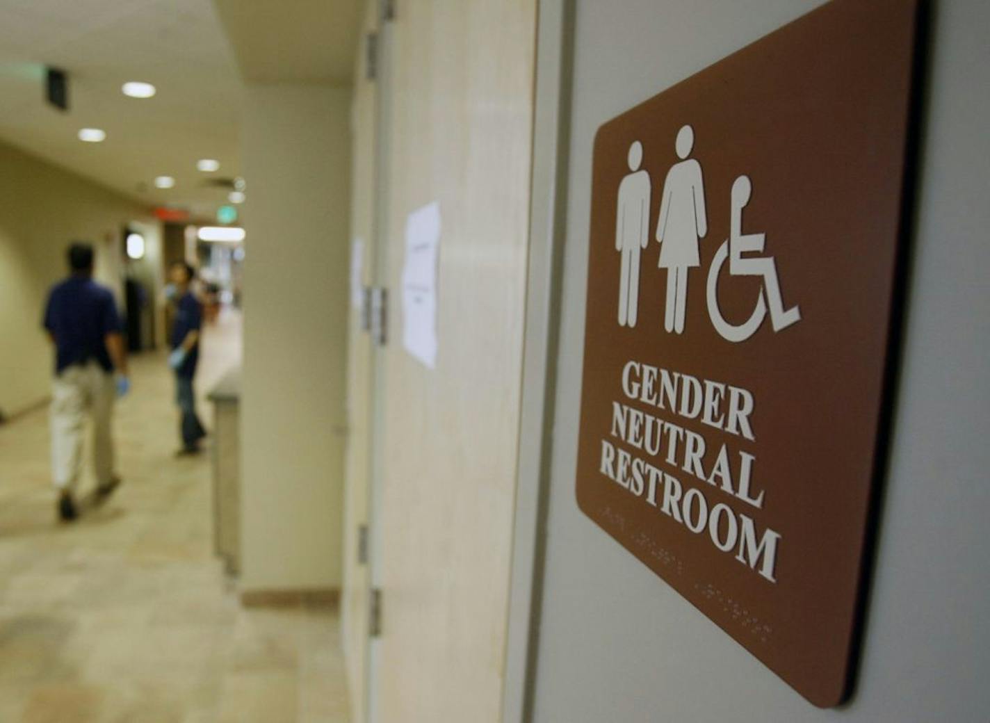 A sign marks the entrance to a gender-neutral restroom at the University of Vermont in Burlington, Vt.