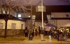 Protesters tried to stay warm and dry in front of the Minneapolis Fourth Precinct. ] (KYNDELL HARKNESS/STAR TRIBUNE) kyndell.harkness@startribune.com 