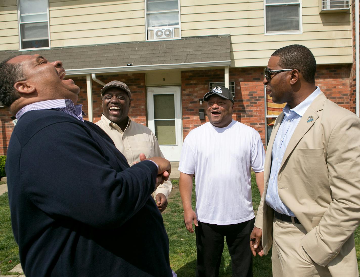 From left, Al Milton, Dwight Smith, Jimmy Calhoun, and NFL great Cris Carter share a laugh about growing up together at Carter's childhood home in Middletown, Ohio, May 7, 2013. Carter, in town for a series of honoree events in advance of his induction into the NFL Hall of Fame this summer, recounted stories of their early football teams in Middletown.