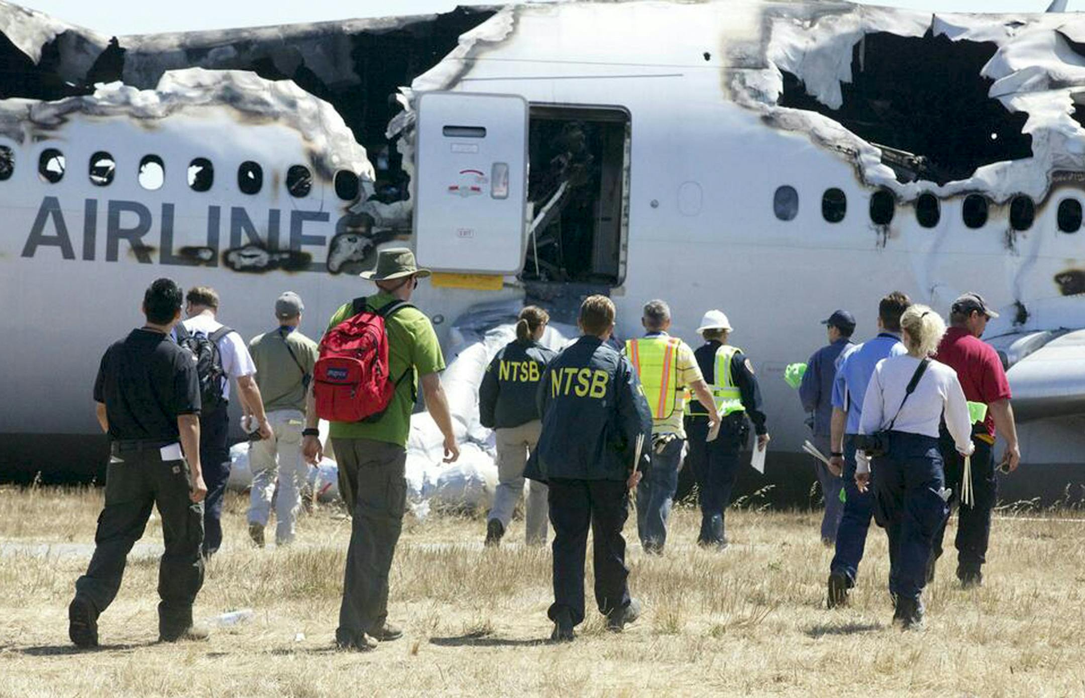 National Transportation Safety Board investigators conduct an assessment of the Asiana Airlines flight that crashed on July 6, 2013 at San Francisco International Airport, in an undated handout photo.