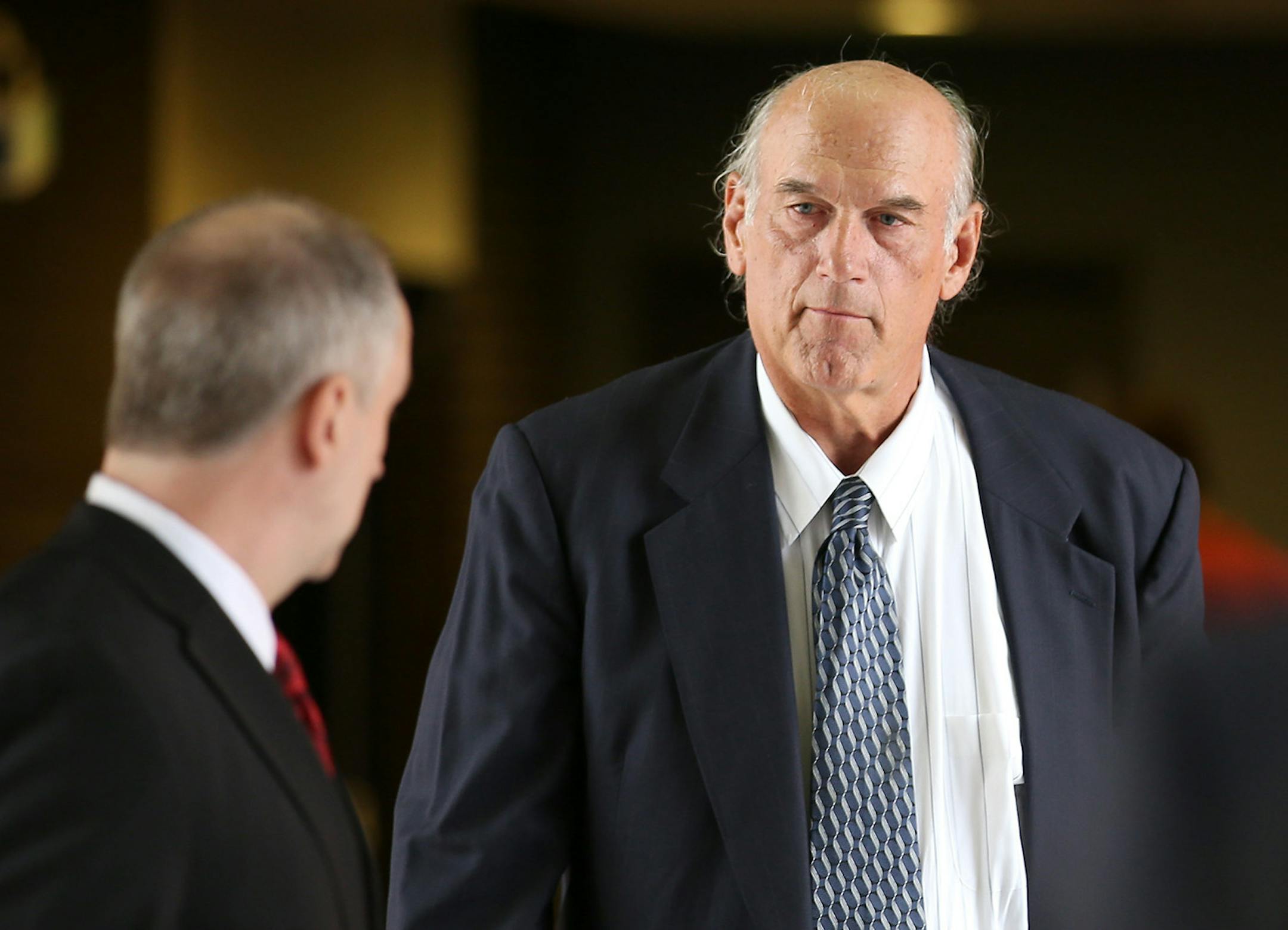 Former Minnesota Gov. Jesse Ventura, right, made his way back into Warren E. Burger Federal Building during the first day of jury selection in a defamation lawsuit, Tuesday, July 8, 2014 in St. Paul, Minn. Ventura filed the defamation lawsuit against the Chris Kyle estate, claiming that Kyle's account of a bar fight in a book he wrote was false. (AP Photo/The Star Tribune, Elizabeth Flores) MANDATORY CREDIT; ST. PAUL PIONEER PRESS OUT; MAGS OUT; TWIN CITIES LOCAL TELEVISION OUT ORG XMIT: MIN2014