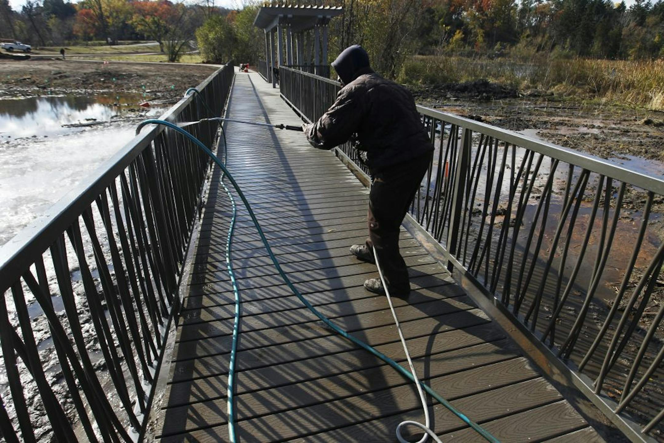Terrance Amos power-washed a boardwalk in Theodore Wirth Park. The Park Board will be taking public input this week on plans for the park.