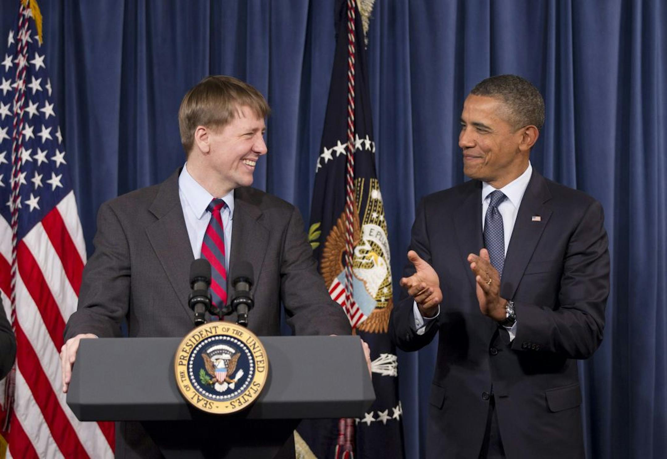 President Barack Obama visits the new director of the Consumer Financial Protection Bureau, Richard Cordray, left, at CFPB's offices in Washington, Friday, Jan. 6, 2012. Obama riled congressional Republicans this week by using a recess appointment, a rarely invoked legal tactic, to appoint Cordray, the former Ohio attorney general to run the watchdog agency.
