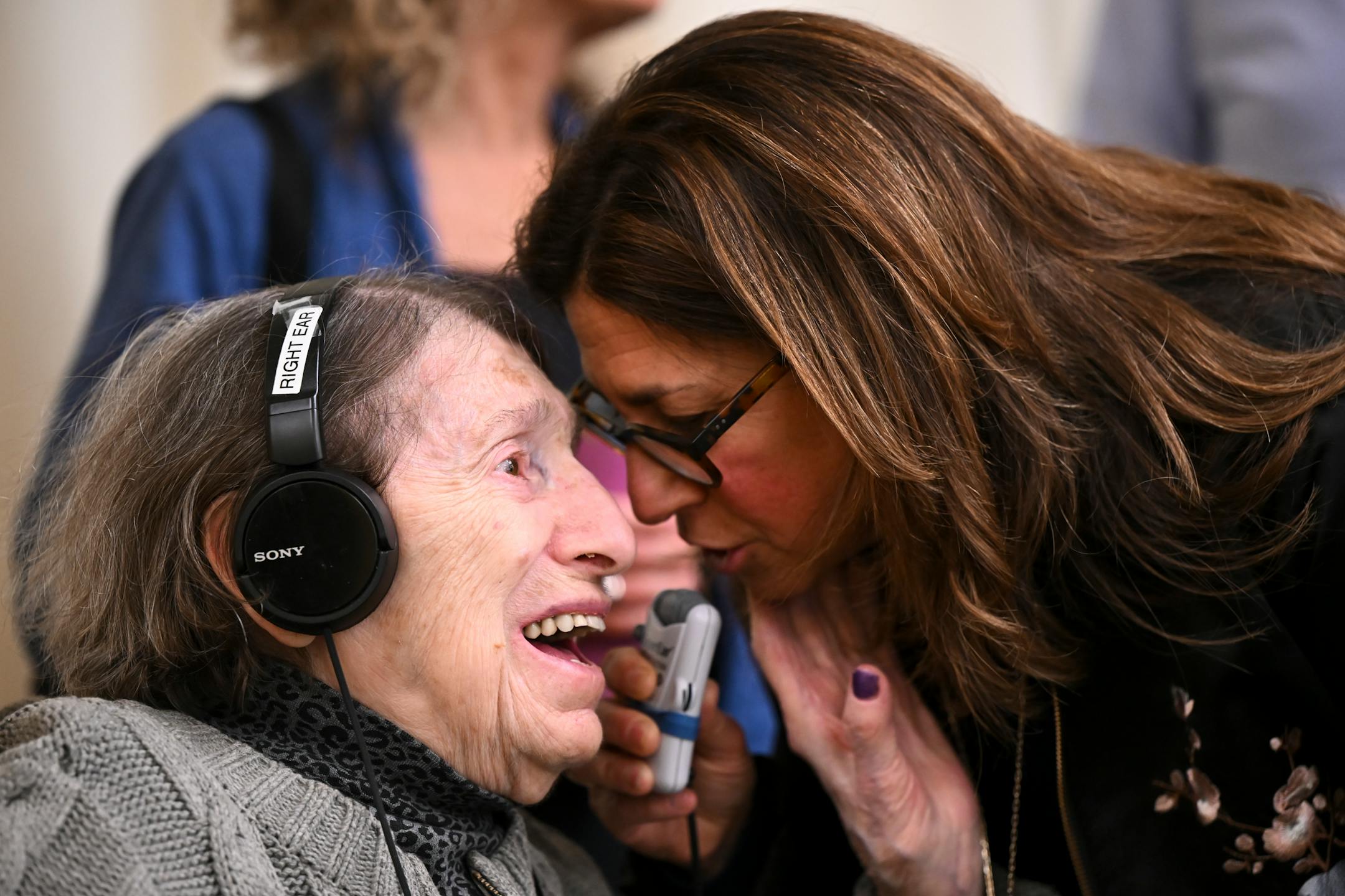 Laura Zelle, right, a child of a holocaust survivor and director of Holocaust education for the Jewish Community Relations Council, leans in to congratulate Dora Zaidenweber after a bill they testified in support of advanced to the education finance committee.