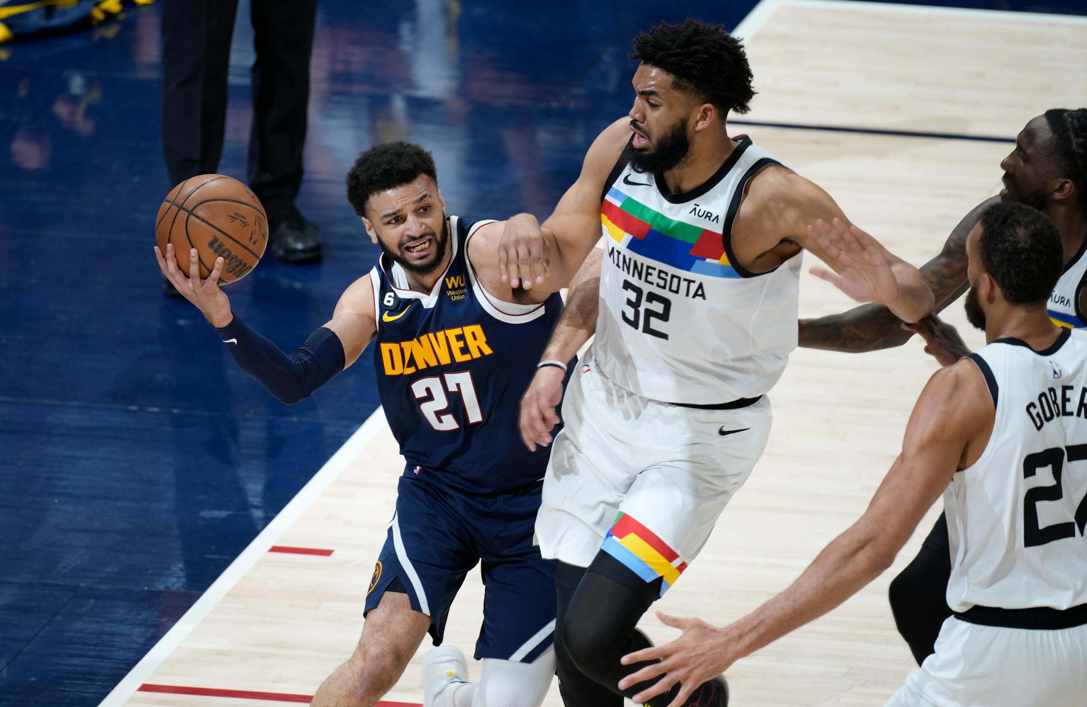 Denver Nuggets guard Jamal Murray, left, is defended by Minnesota Timberwolves center Karl-Anthony Towns during the first half of Game 2.