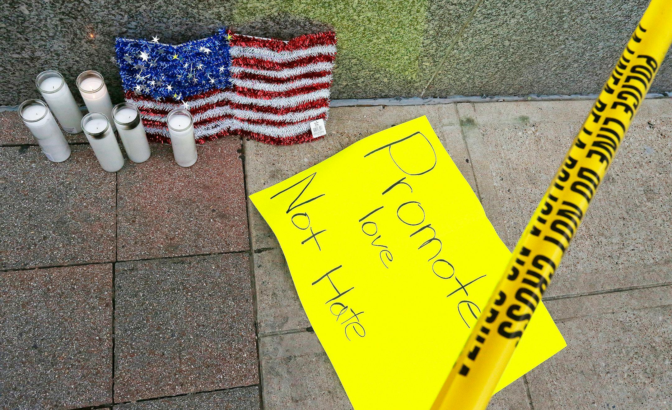 A small memorial at the Greyhound Bus Station in Dallas about a block from the scene where five officers were fatally shot and seven others were wounded Thursday in what was apparently a retaliatory ambush by a sniper.