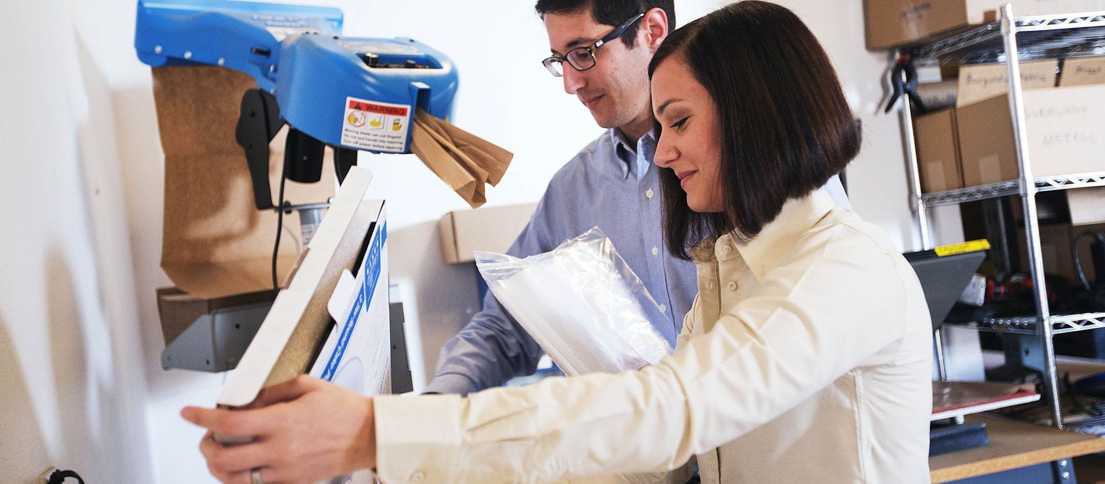 In this Sunday, Feb. 22, 2015 photo, Daniel Rensing, left and his wife Stephanie, owners of The Smart Baker, work in their warehouse in Rockledge, Fla. Annual revenue for their company is close to $1 million, up from $130,000 before their March 2012 appearance on the reality TV show "Shark Tank". (AP Photo/David Goldman) ORG XMIT: NYBZ128
