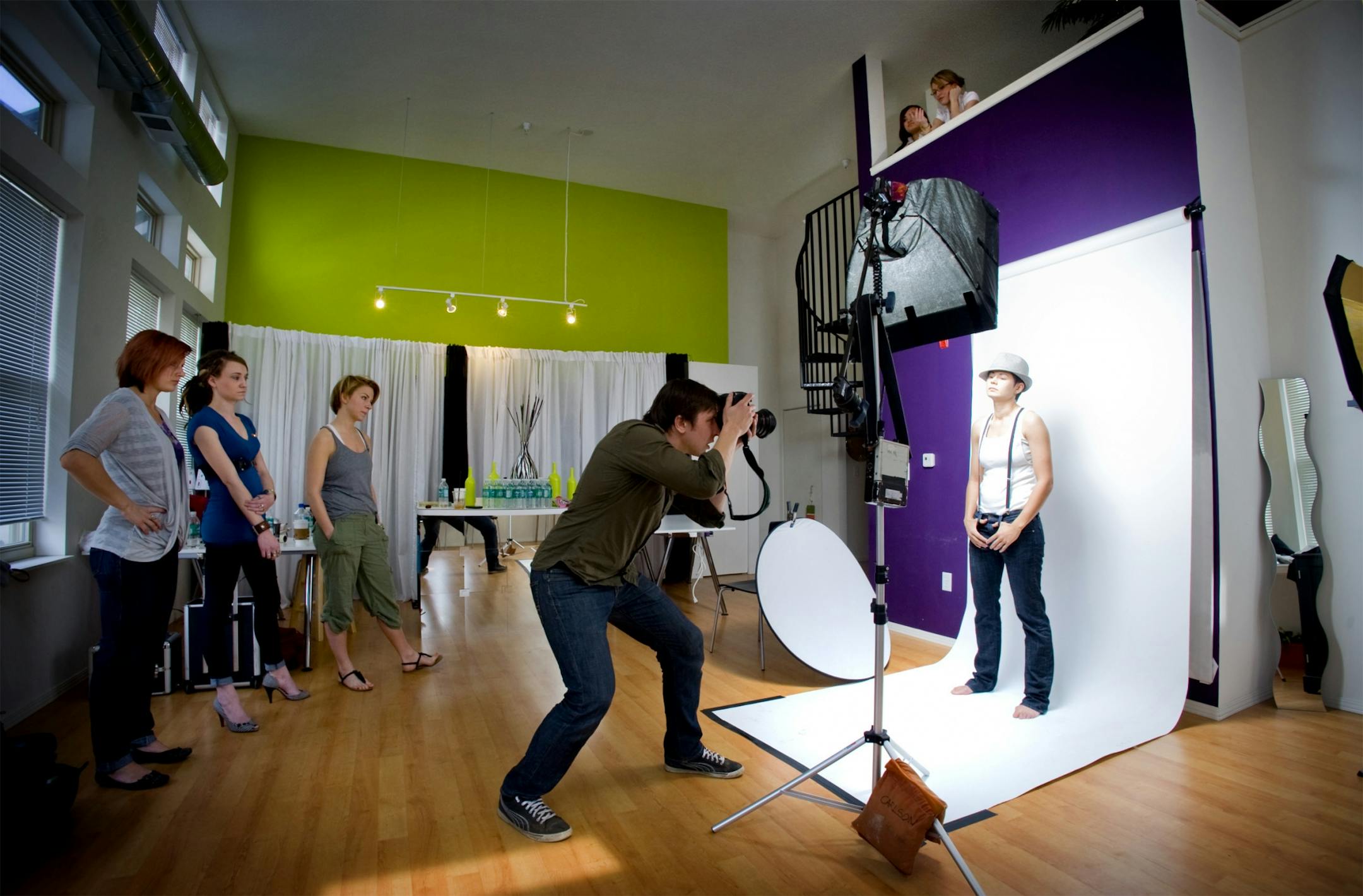 Ashley Powell above, rents a live/work apartment in and runs her modeling agency *A|star Agency there. Here photographer Marshall Franklin Long directed model Jess Santiago during a portfolio shoot. Helping with the shoot were members of the modecadent collective, hair stylist Rachel Costello, fashion stylist Nena Englund and Becca May make-up artistry.