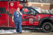 A health care professional wept Monday near a paramedic vehicle that has become one of three memorials in front of the Burnsville Police Department.