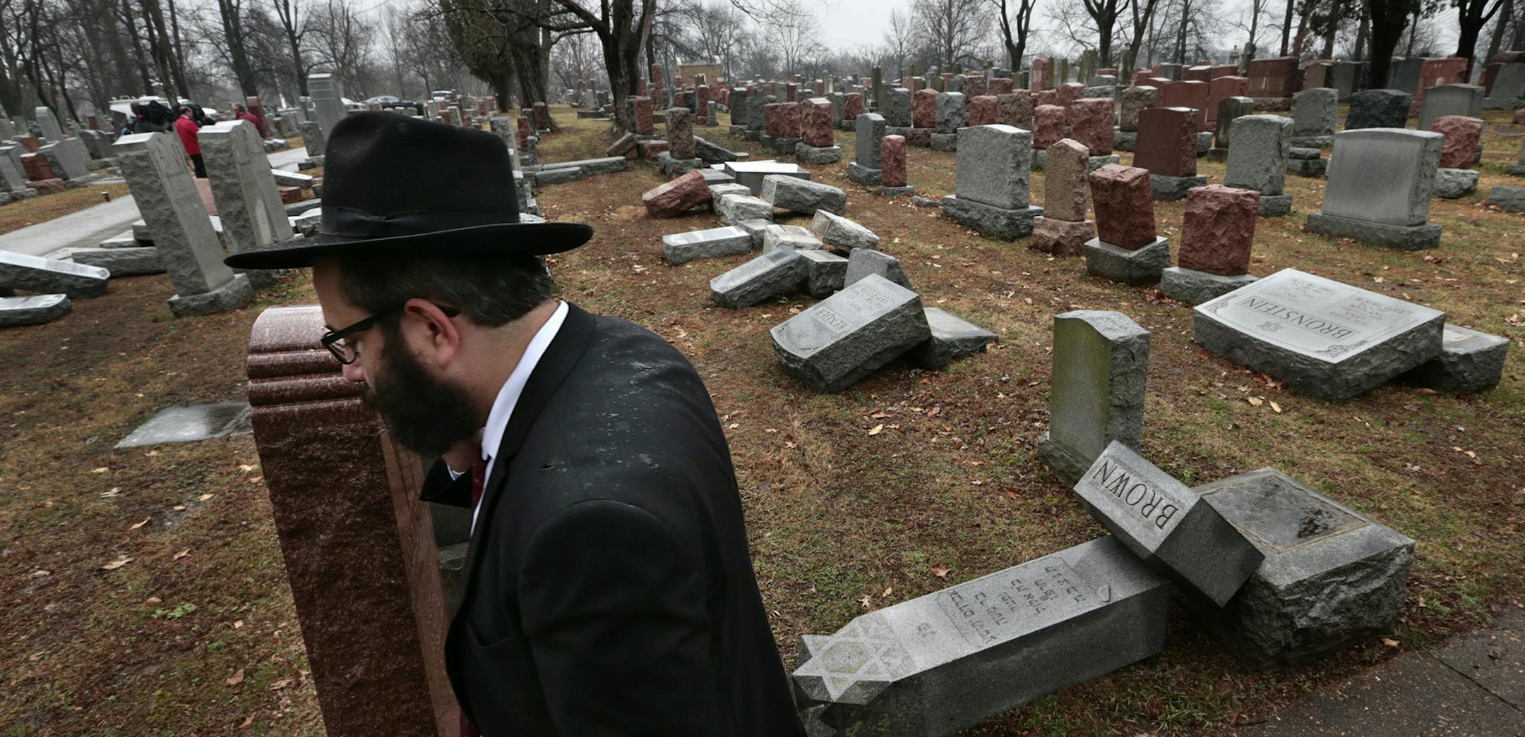 Rabbi Hershey Novack of the Chabad center walks through Chesed Shel Emeth Cemetery in University City, Mo., on Tuesday, Feb. 21, 2017, where almost 200 gravestones were vandalized over the weekend. "People who are Jewish are shocked and angry," Novack said. (Robert Cohen/St. Louis Post-Dispatch via AP) ORG XMIT: MIN2017022214180123