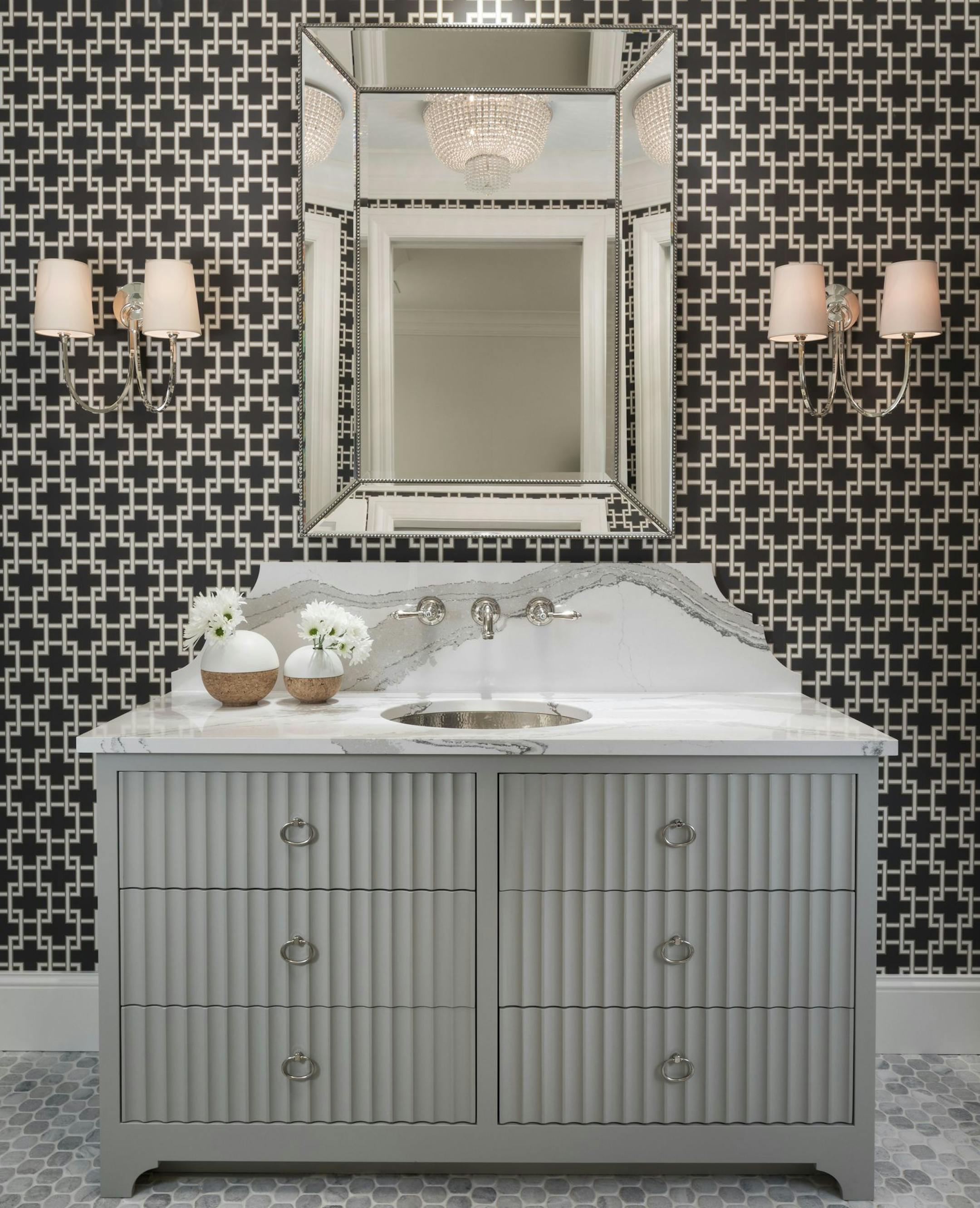 The powder room makes a bold statement with geometric patterned wallpaper, marble-veined quartz backsplash and reflective design elements, Artisan Home #9.