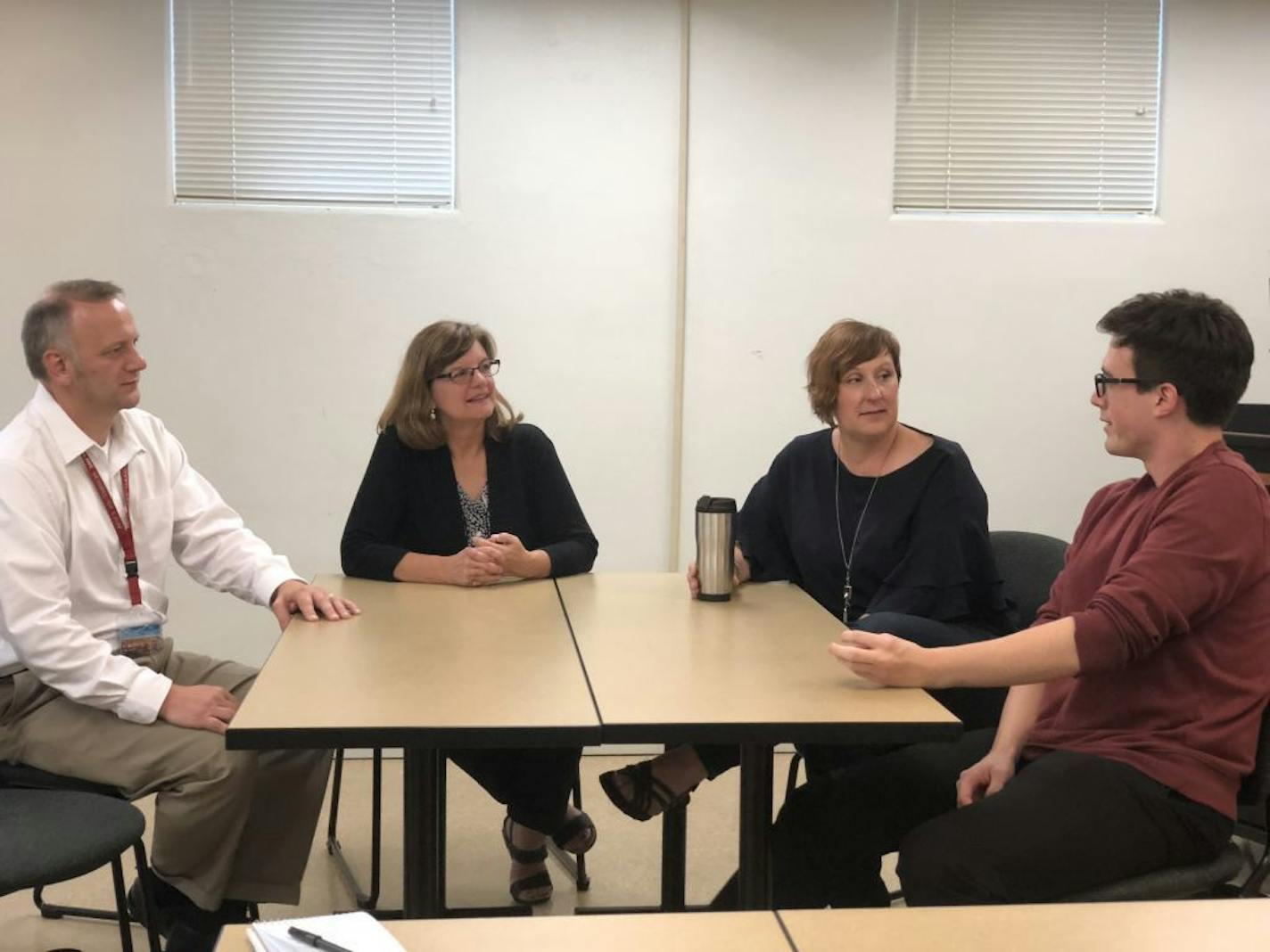 From left to right, Jeremy Jackson, Susan Myster, Amanda Gronhovd and Kyle Knapp discuss their work on the Historical Human Remains project, a state-funded push to identify and bury unidentified human remains.