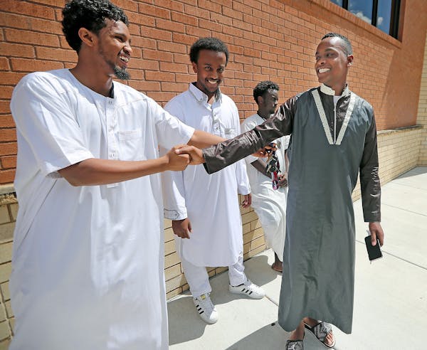 Mohamoud Ibrahim, right, a specialist in the Army Reserve, said goodbye to his friends after the Friday prayer at the Islamic Institute of Minnesota's